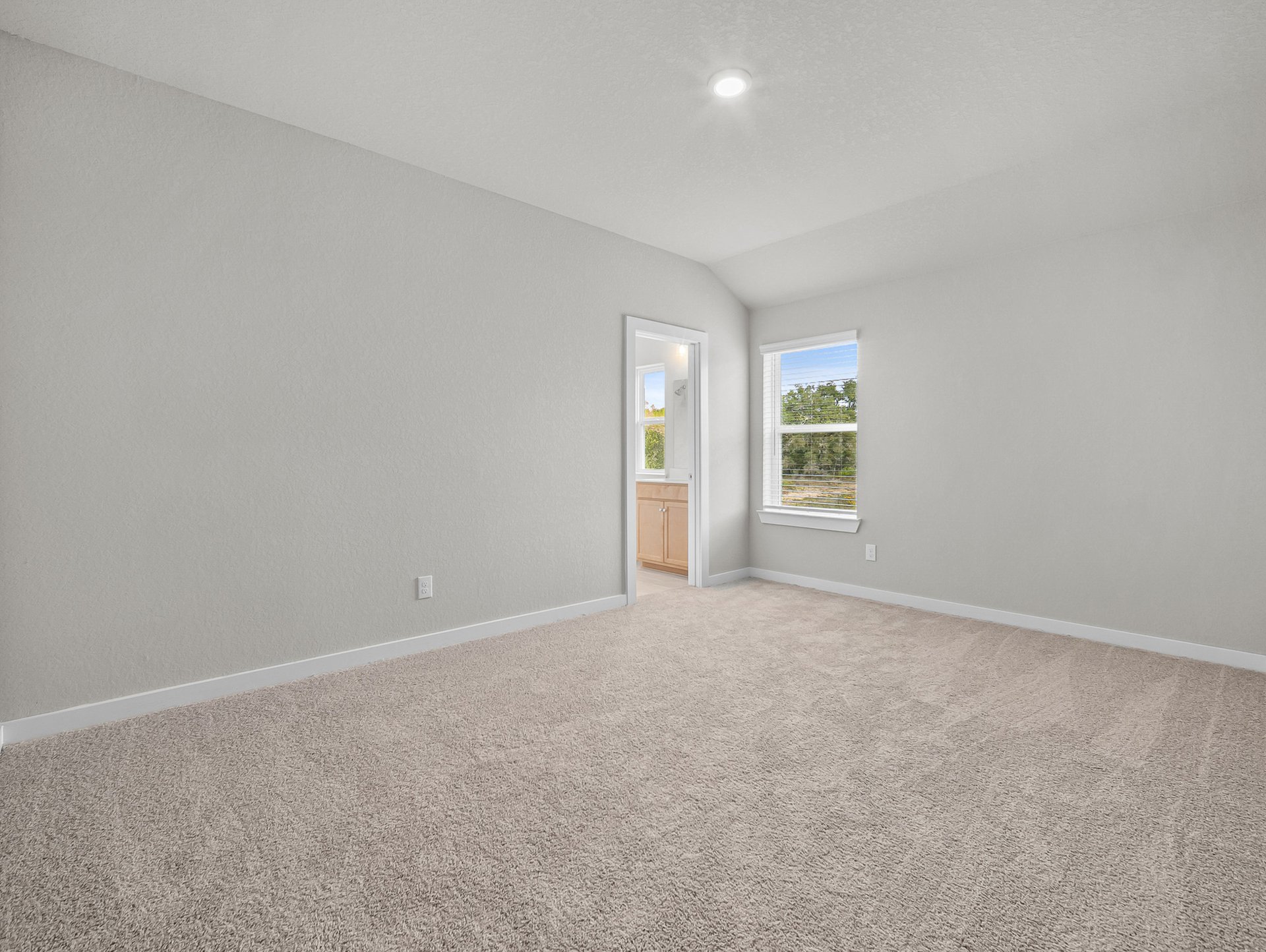 bedroom with carpet, window & a sloped ceiling