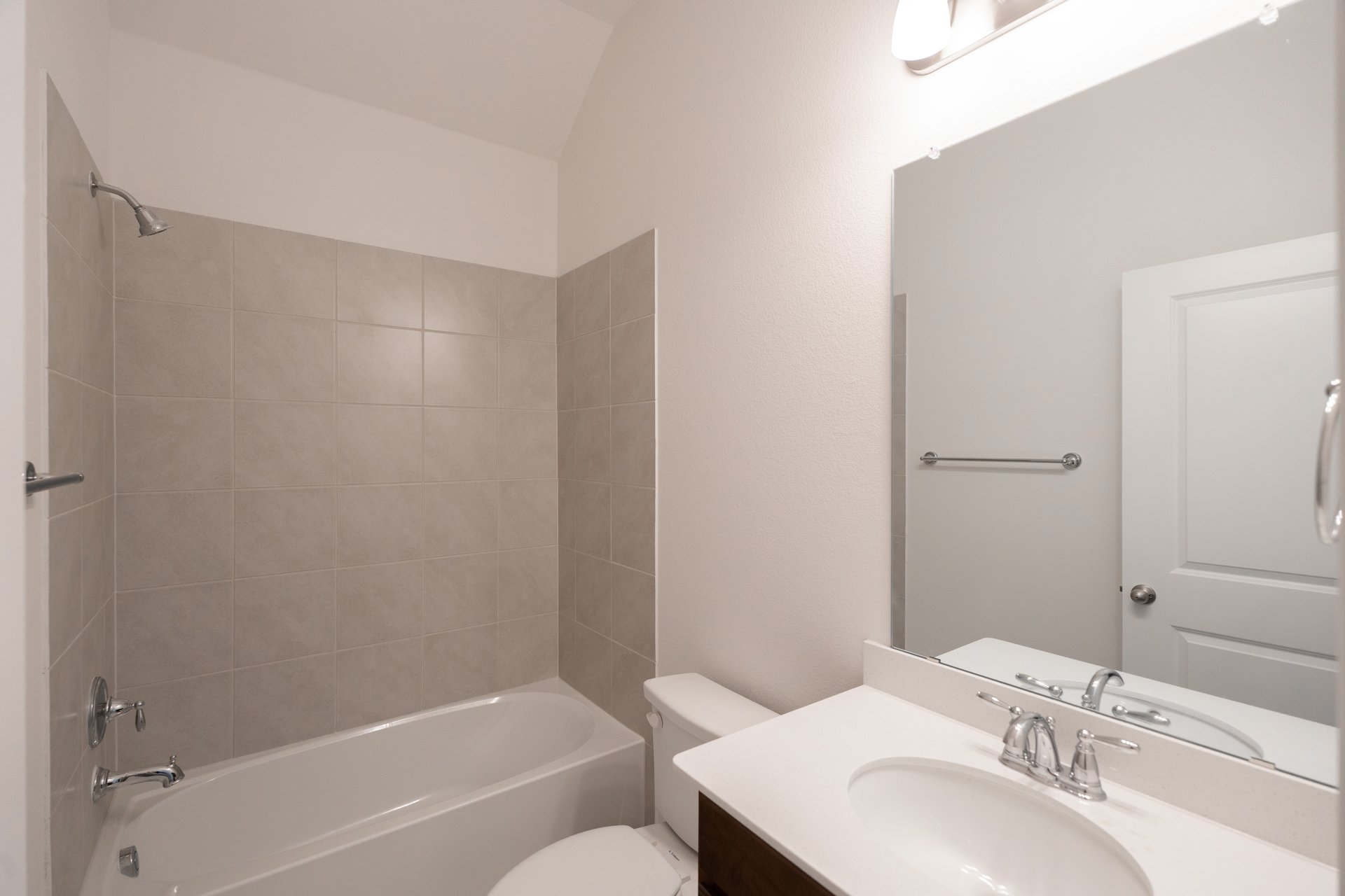 bathroom with tub and white countertop 