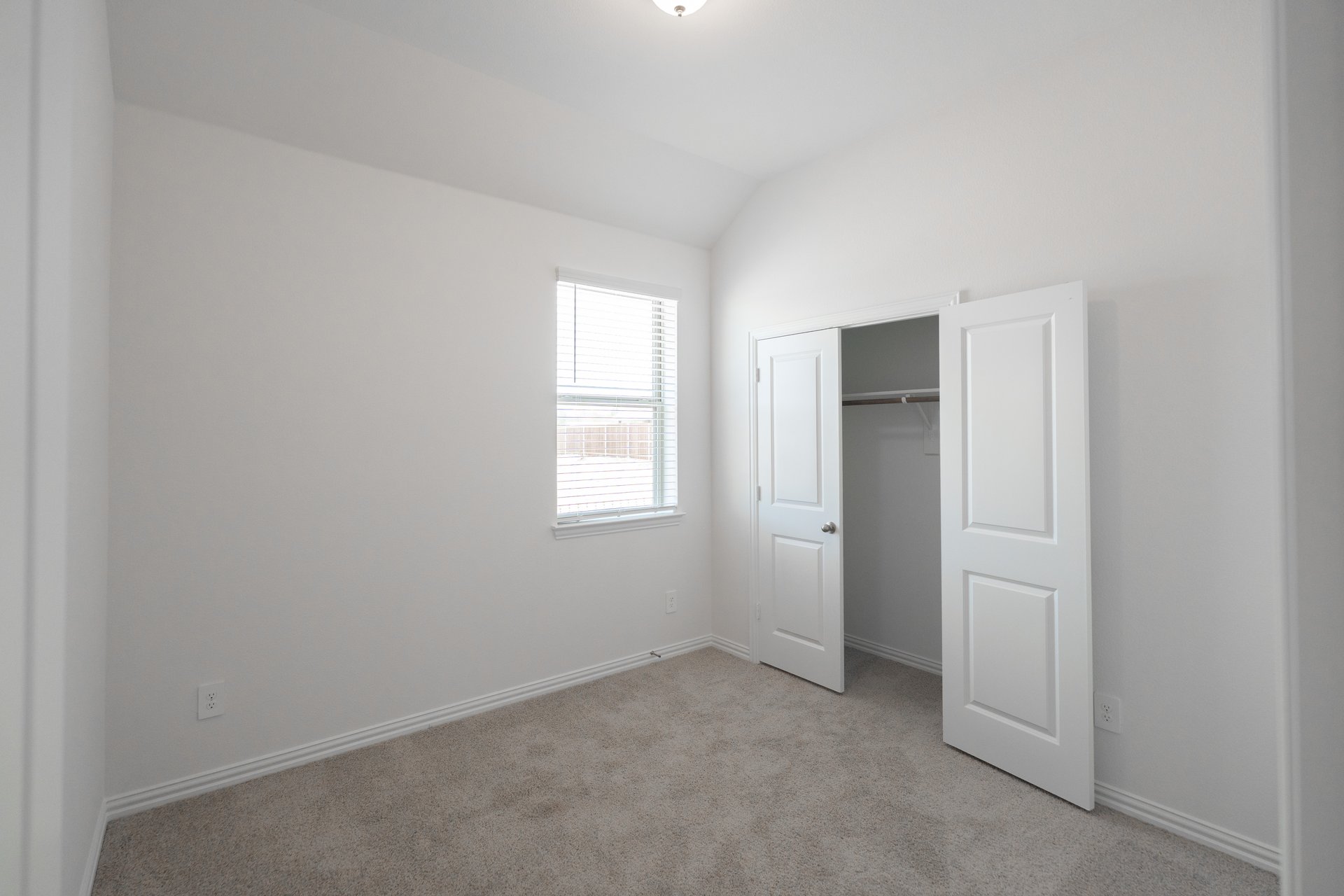 bedroom with carpet and window with blinds 