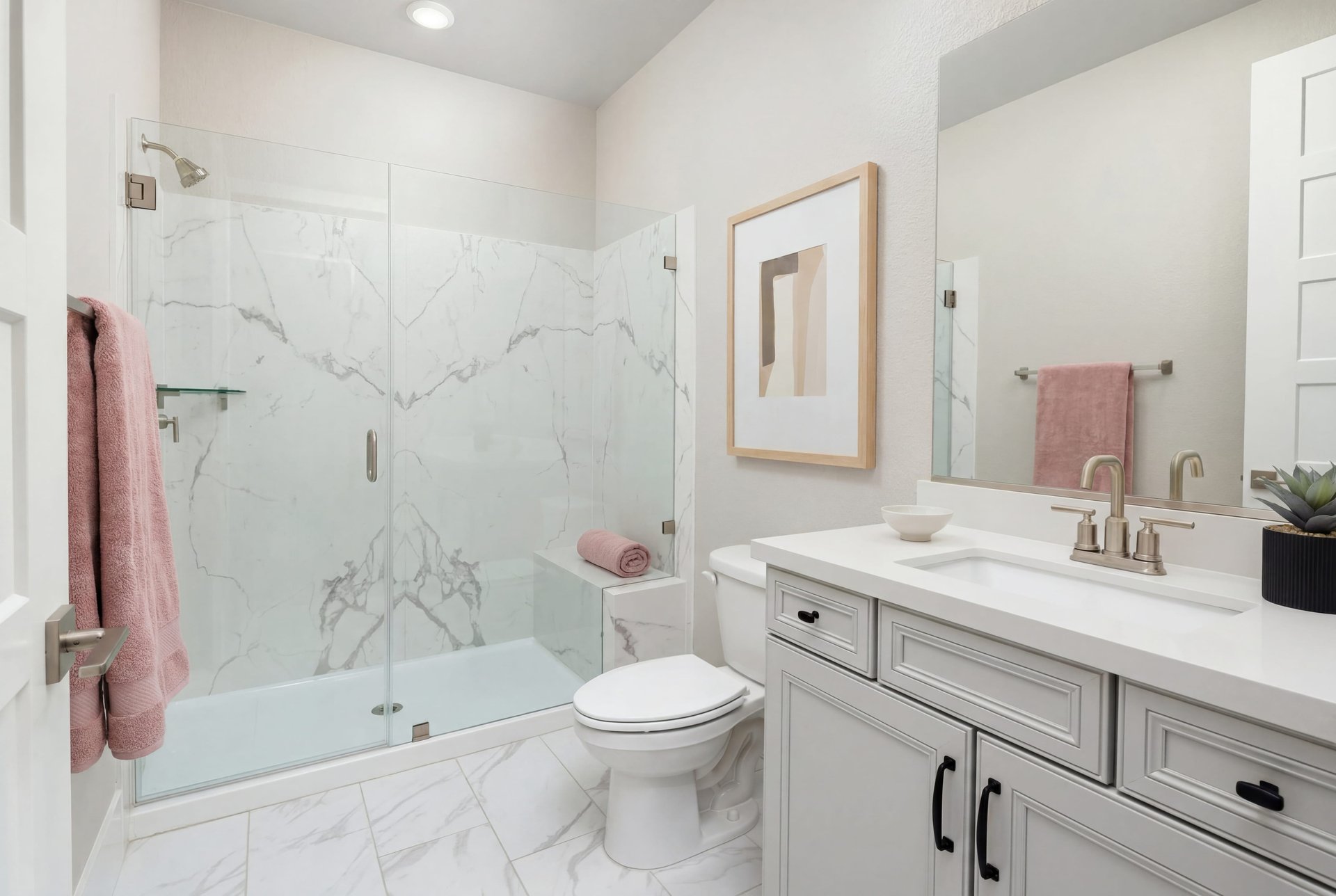 bathroom with white cabinets and counters, large walk-in shower with white quartz surrounds and frameless glass enclosure, and pink towels