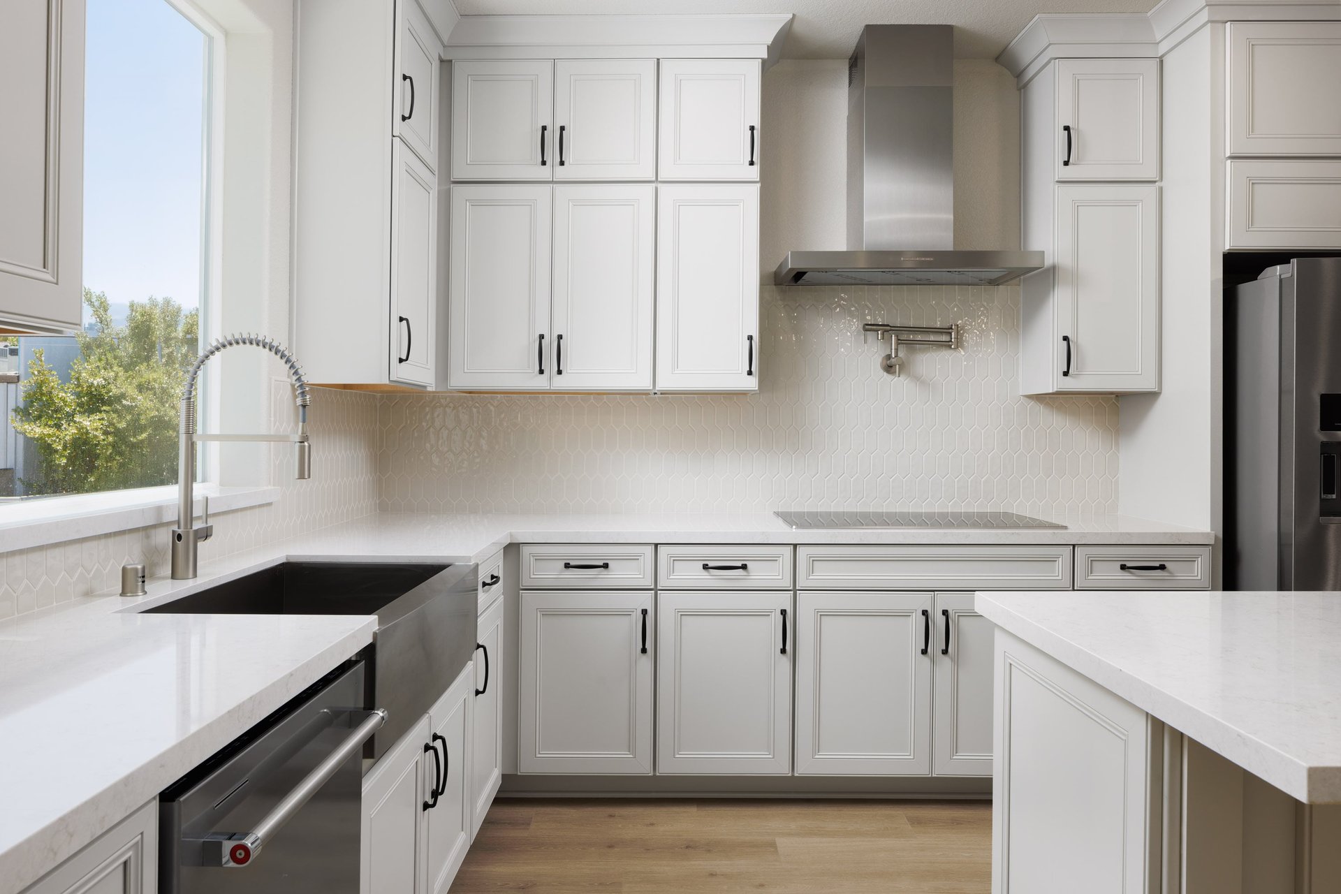 kitchen with white ceiling height cabinets, white quartz counters, and window over sink