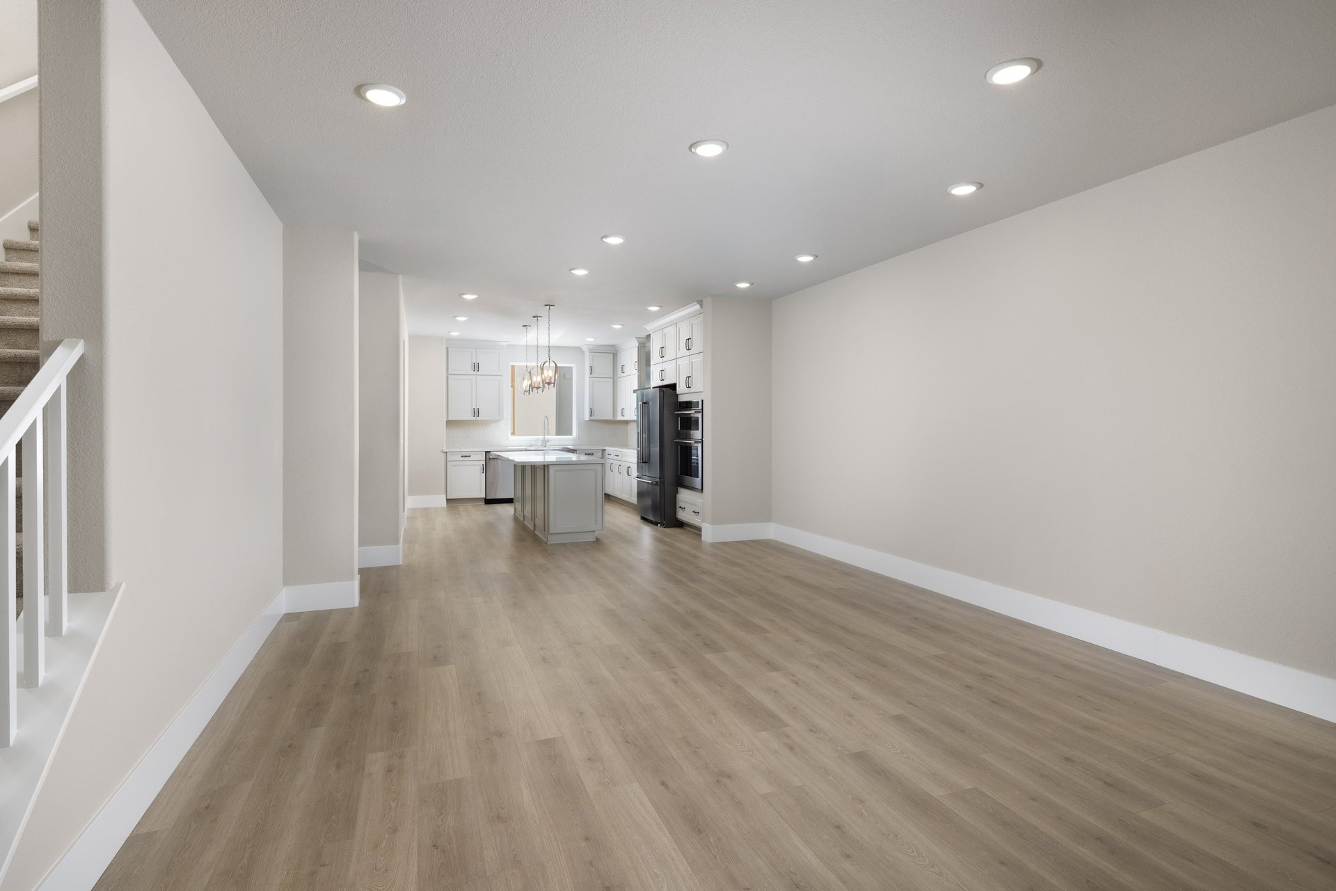 great room with wood floors, recessed ceiling lights, and view of kitchen