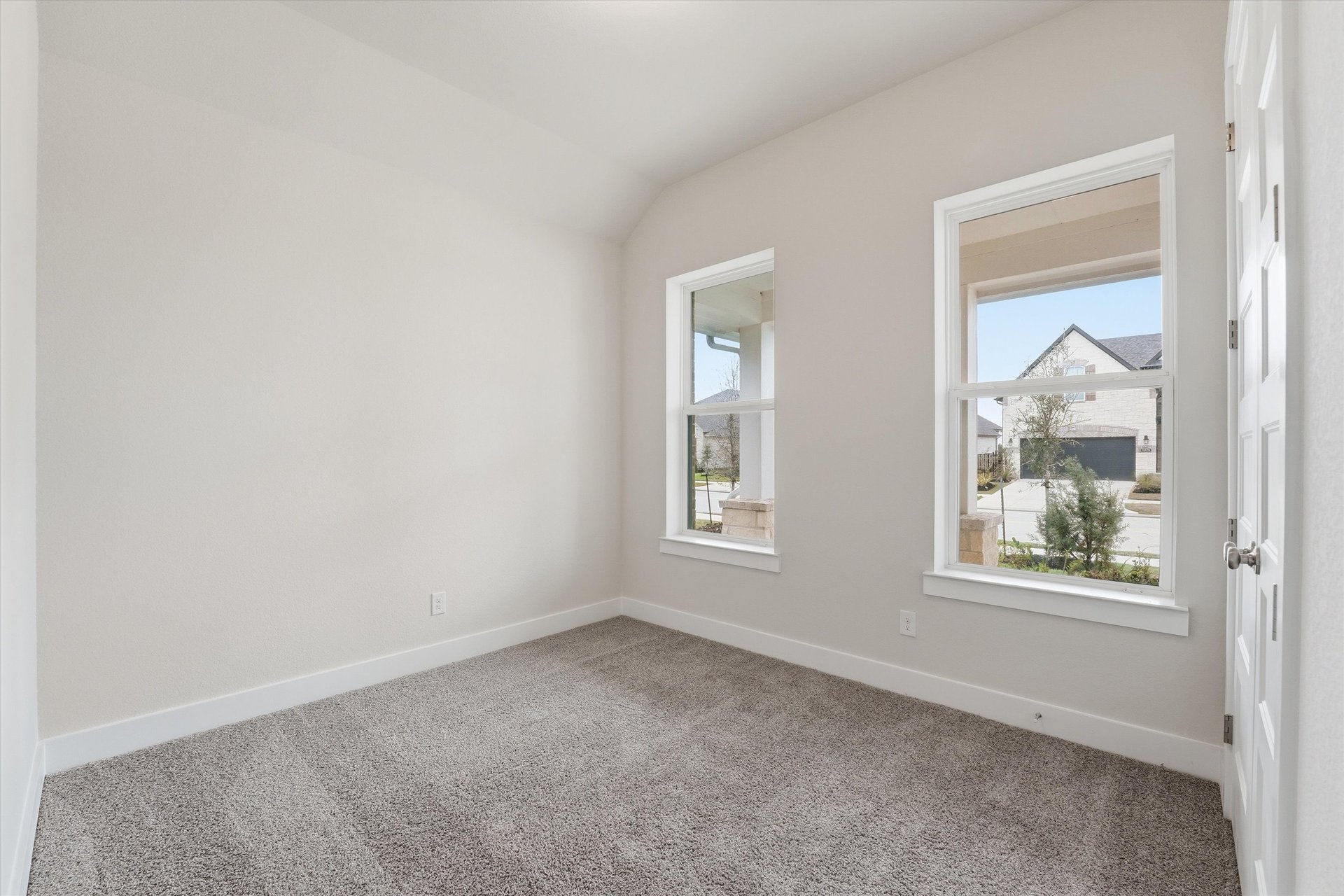 guest bedroom with carpet and windows