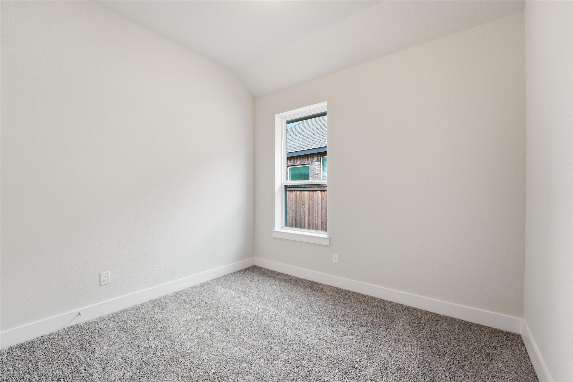 guest bedroom with carpet and window