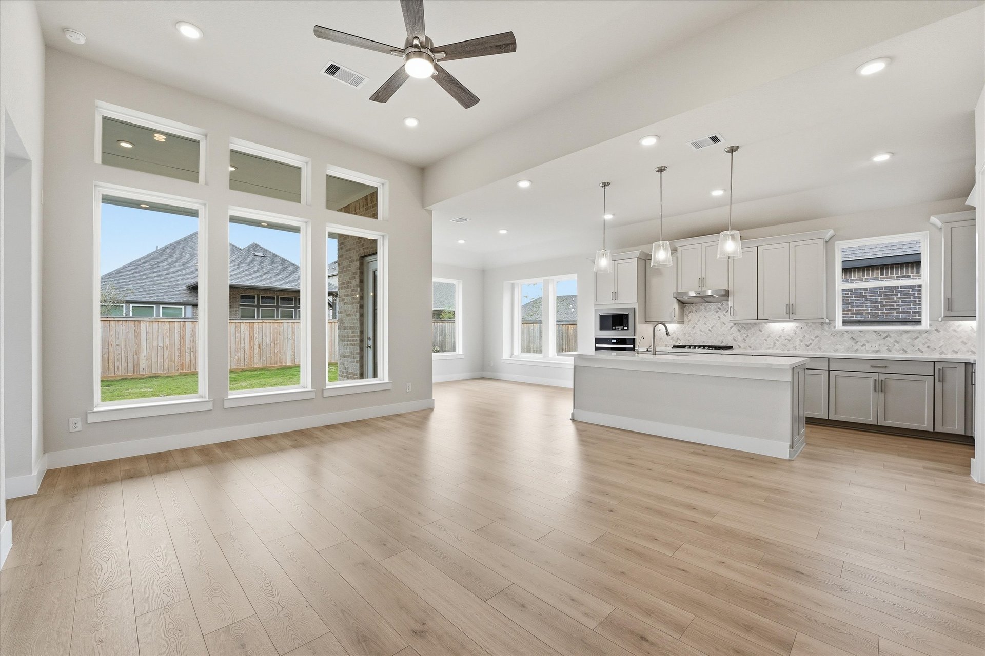 open great room with hardwood flooring and windows