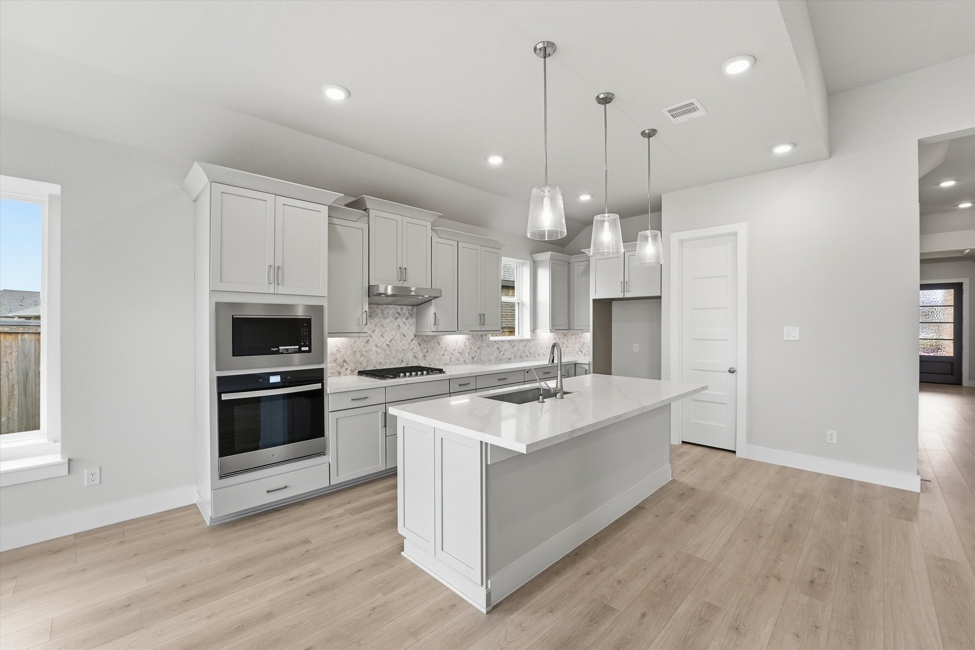 open kitchen with light gray cabinets