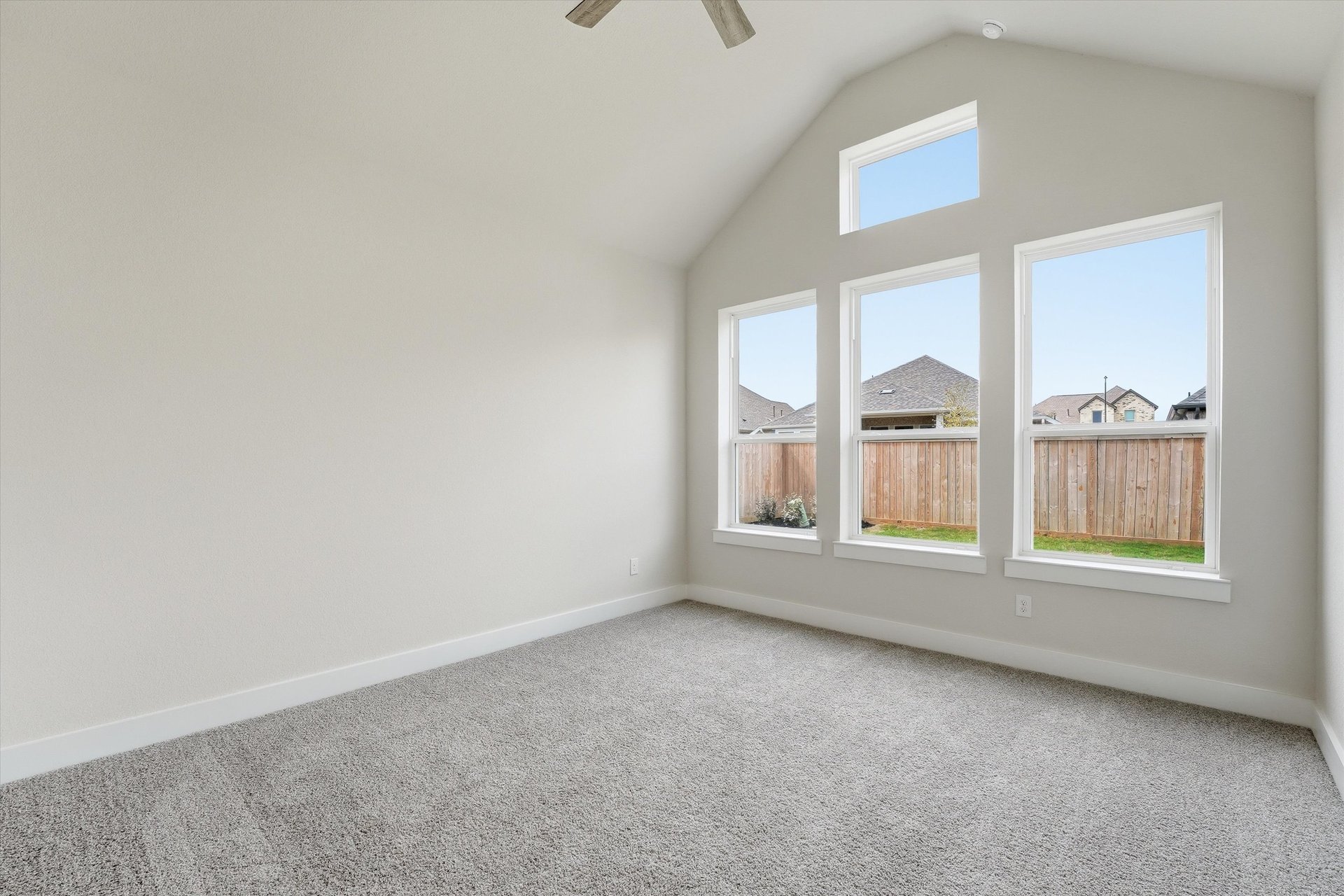 primary bedroom with vaulted ceilings