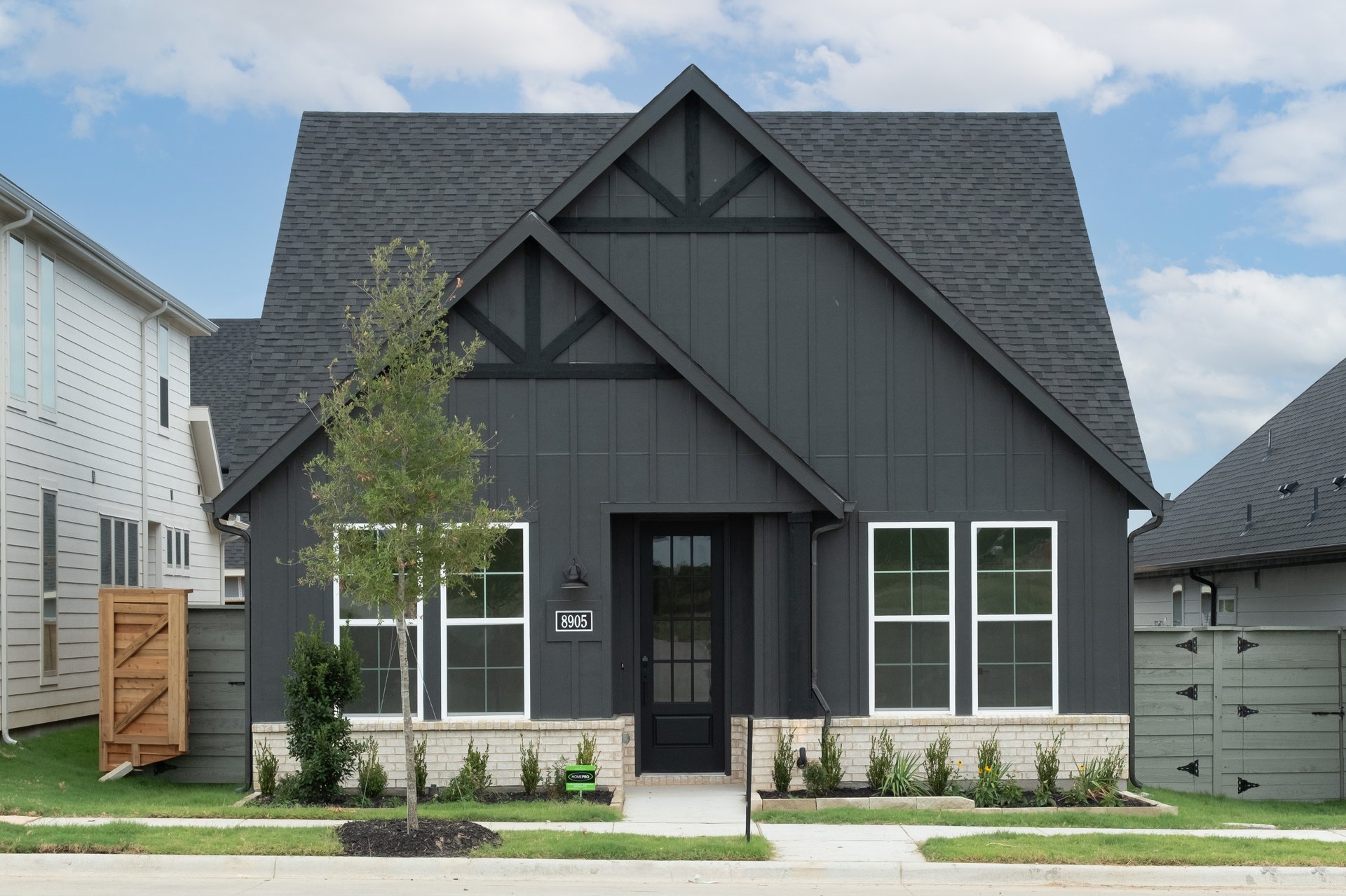 exterior of home with black siding and white stone