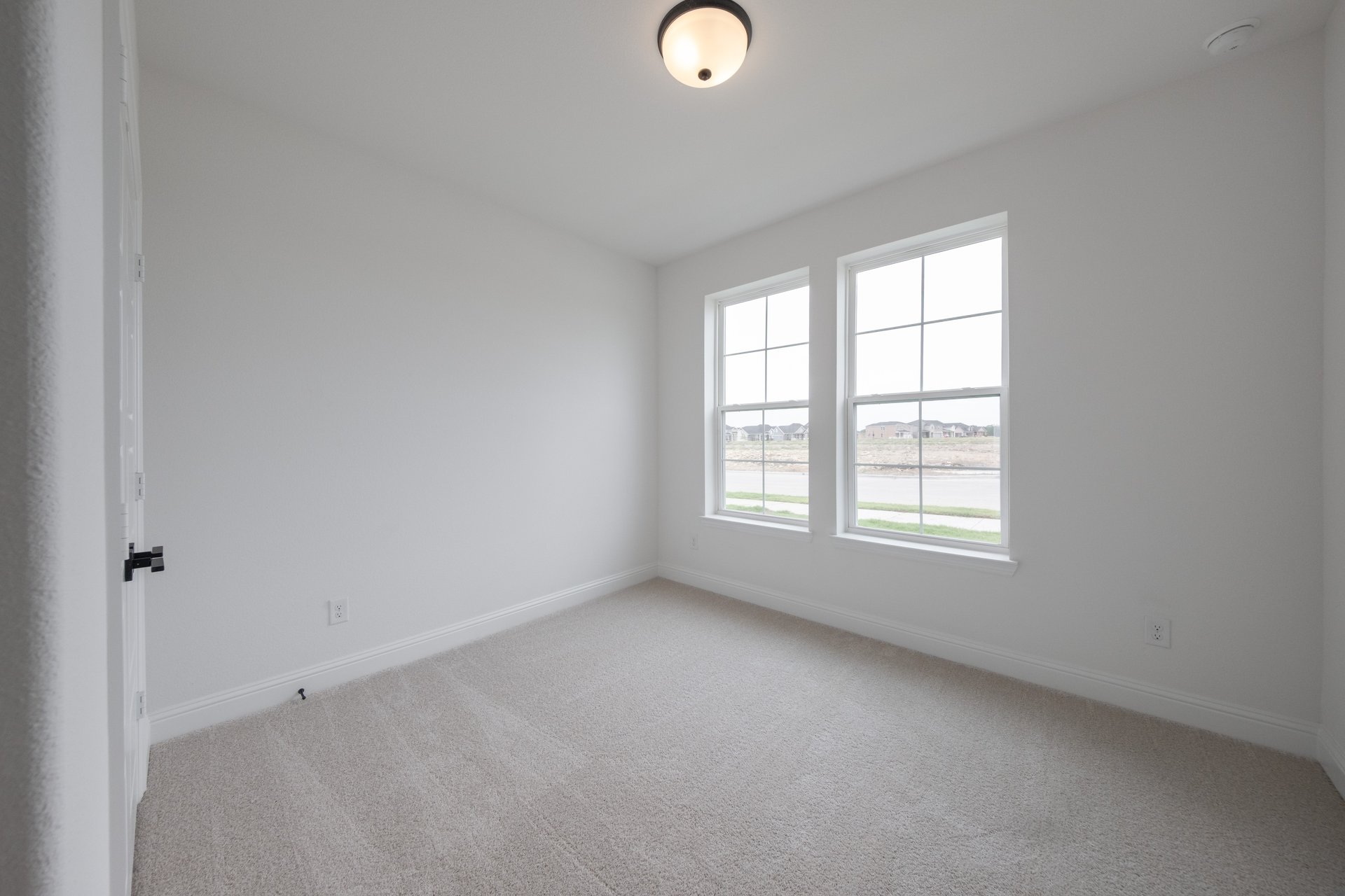 guest bedroom with carpet and window