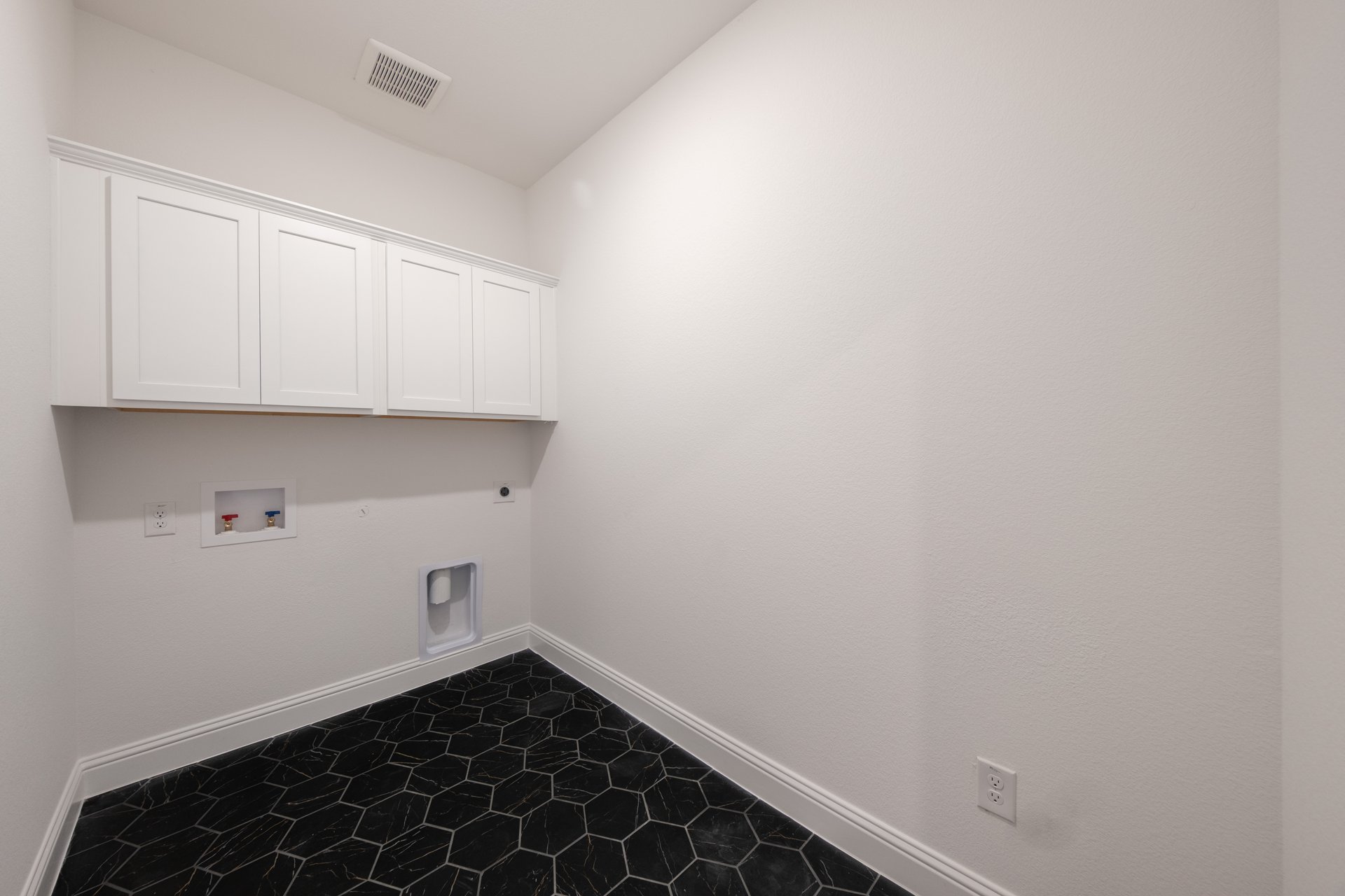 spacious laundry room with storage shelf