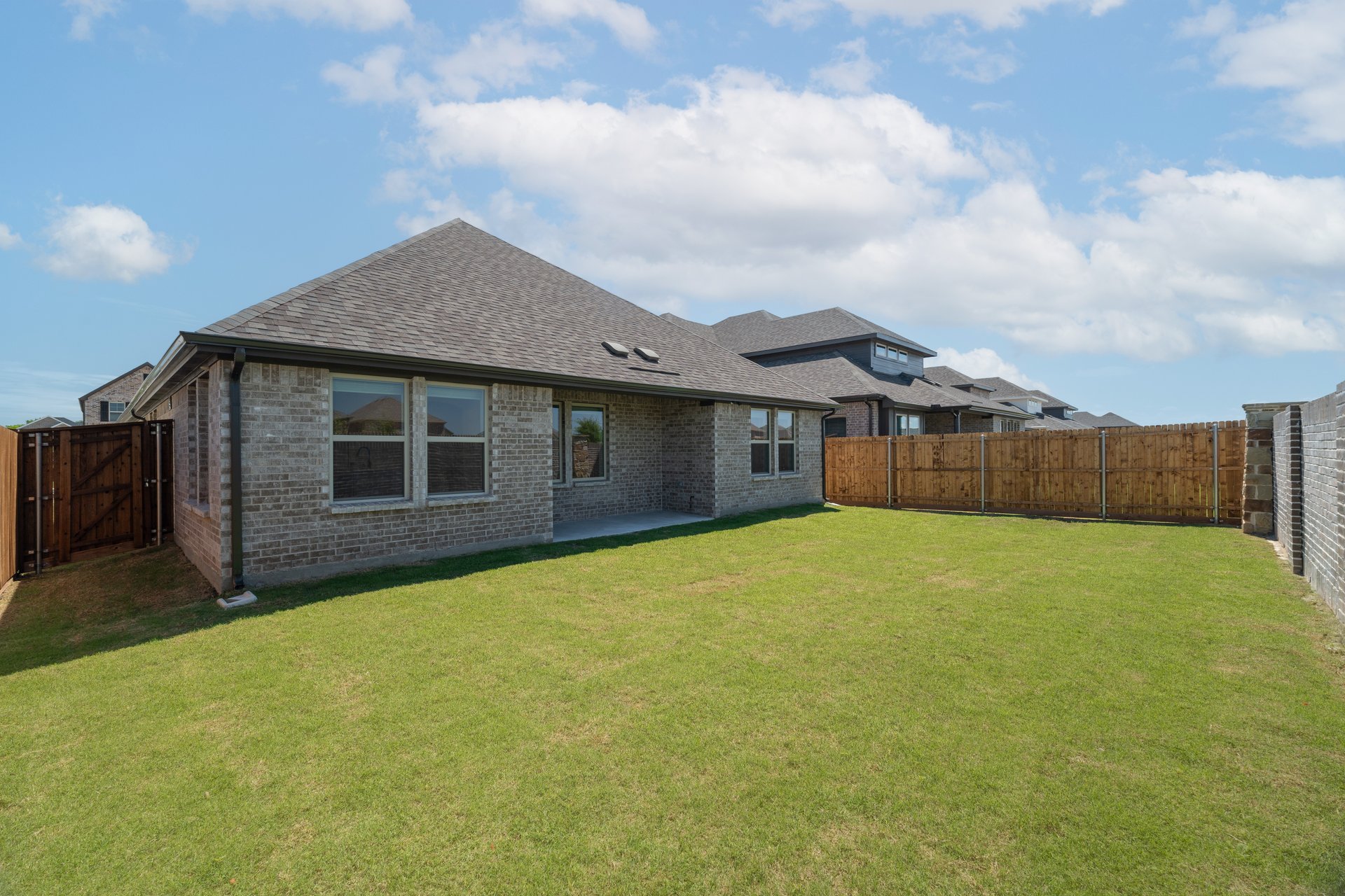 backyard with grass and covered patio