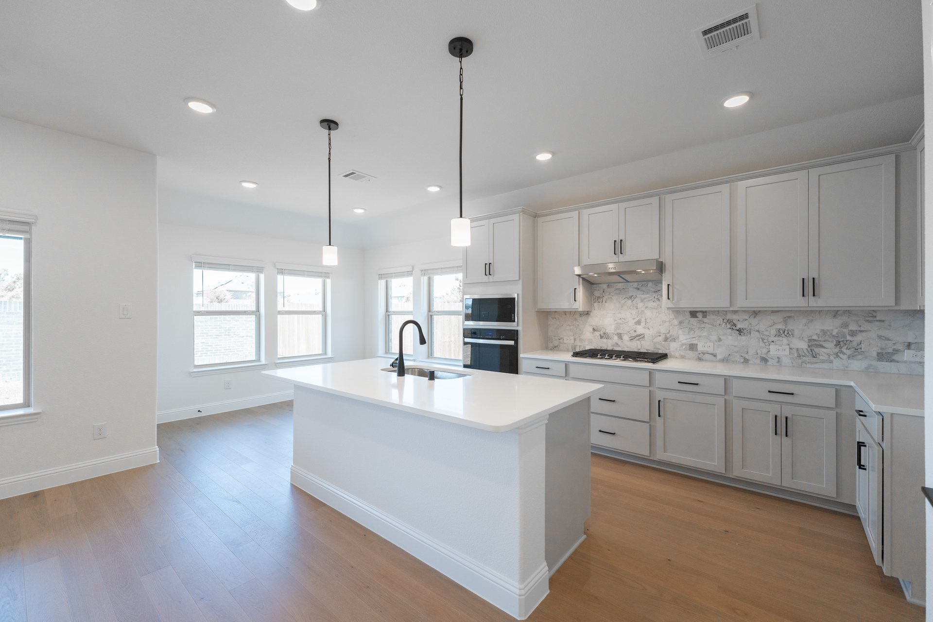 open kitchen with wood floors and island