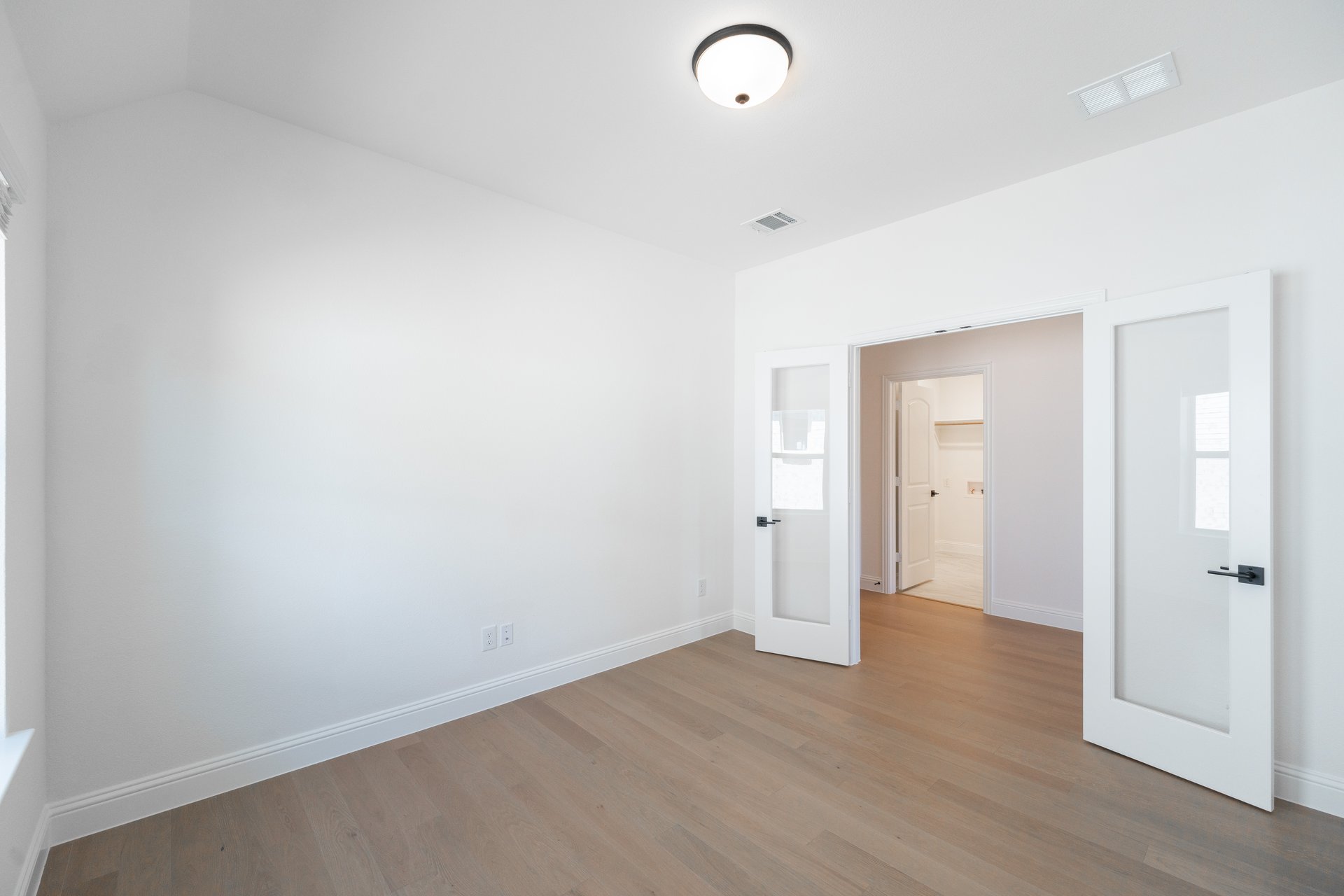 private study with wood floors and french doors