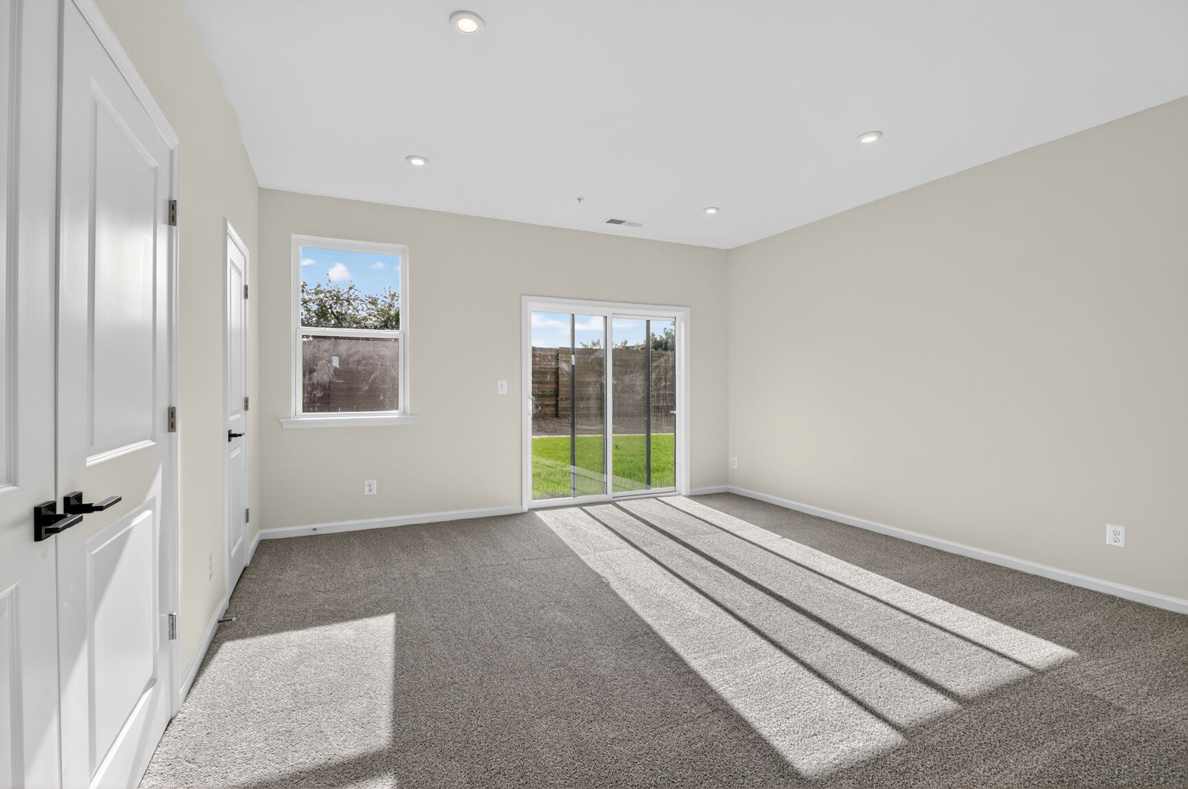 main level finished recreation room with carpet
