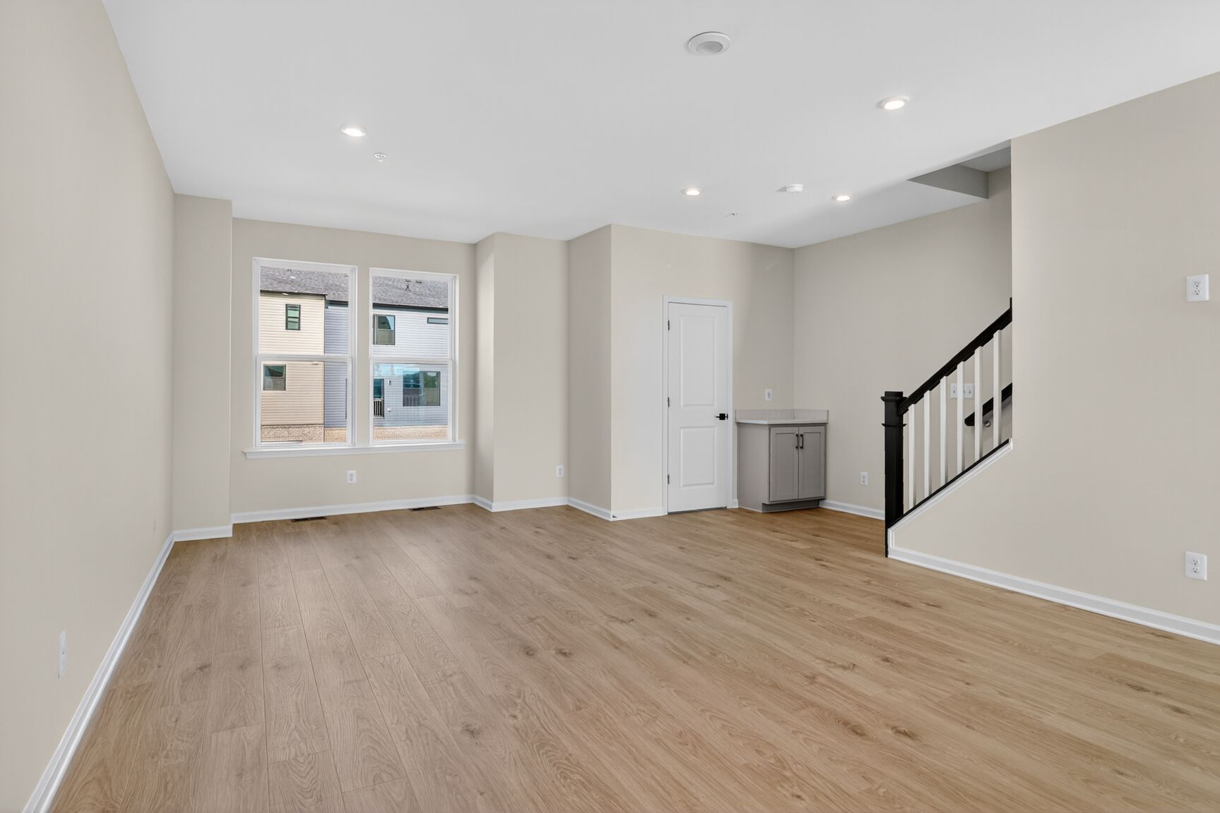 great room with designer flooring featuring valet and powder room