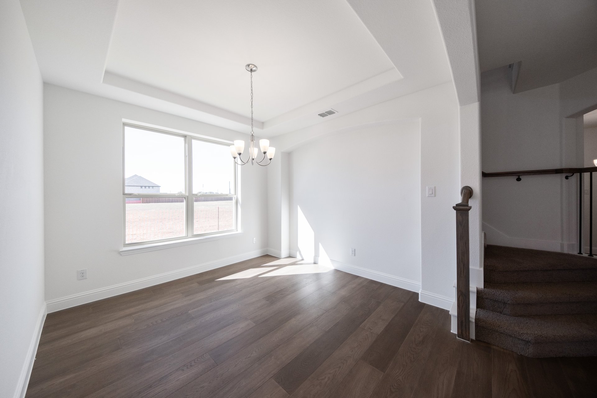 dining room with large window and chandelier 