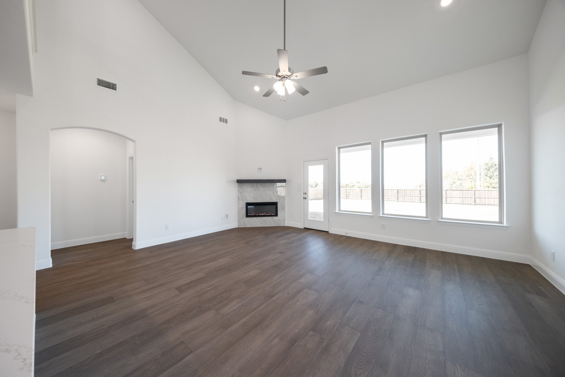 great room with fireplace and wood flooring 