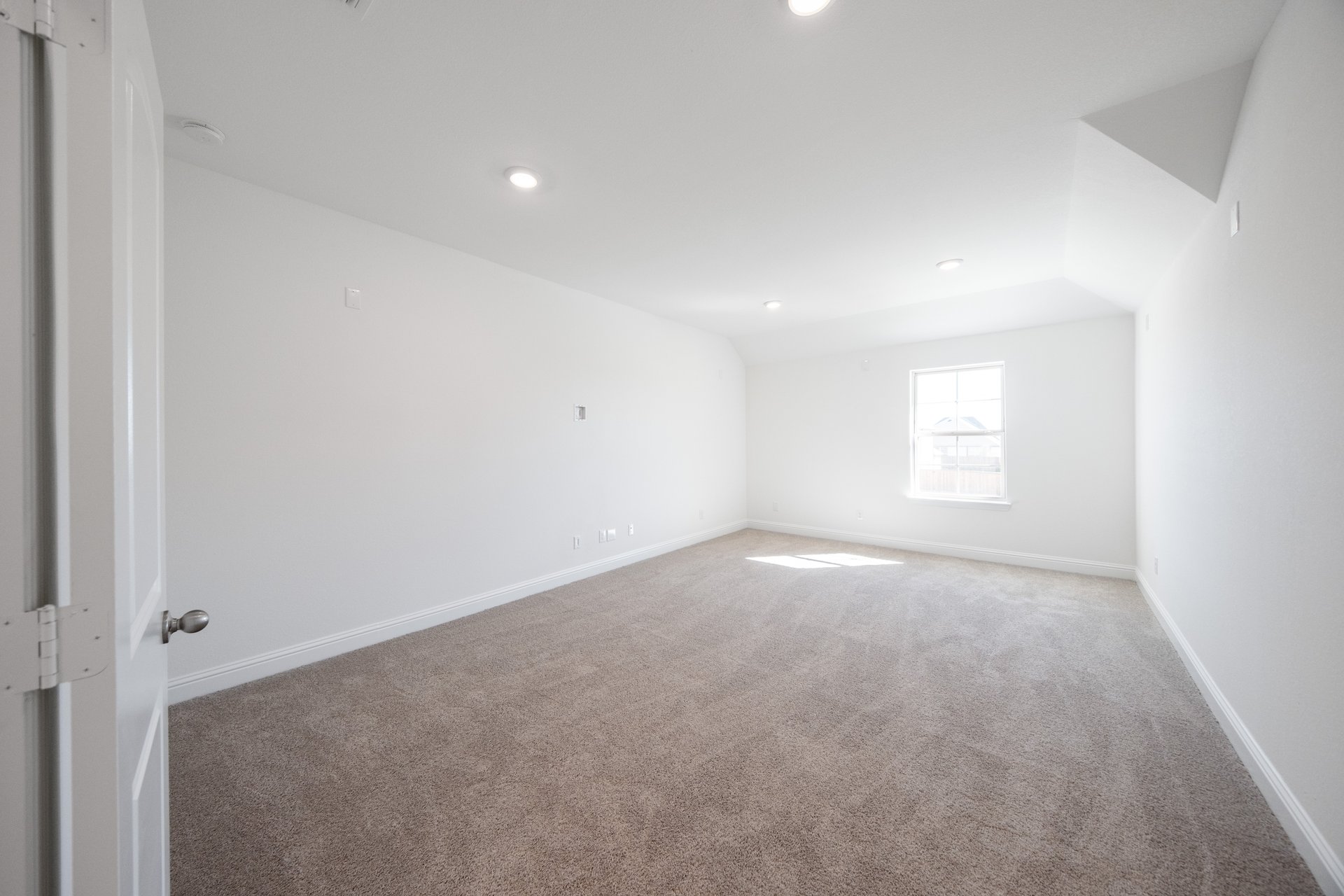media room with carpet and window 