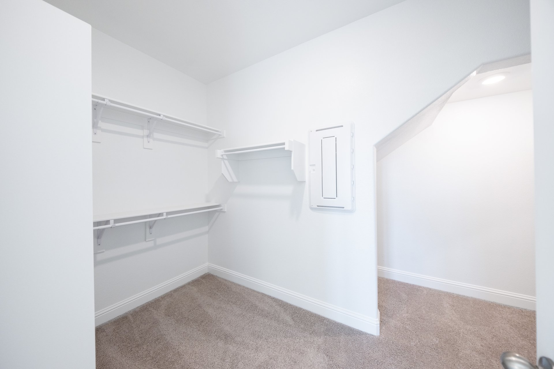 closet with hanging racks and storage area 