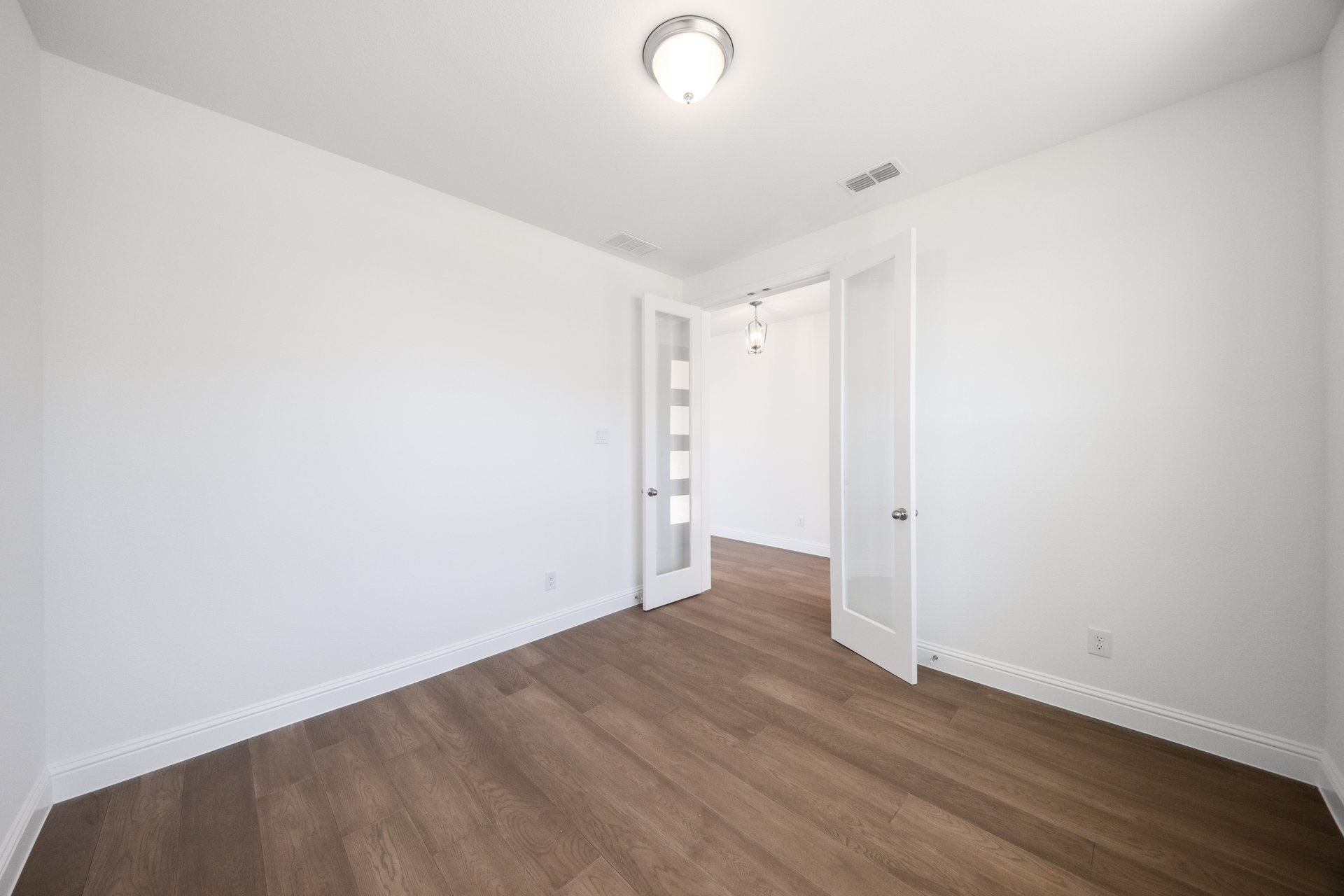 study with wood flooring and french doors 