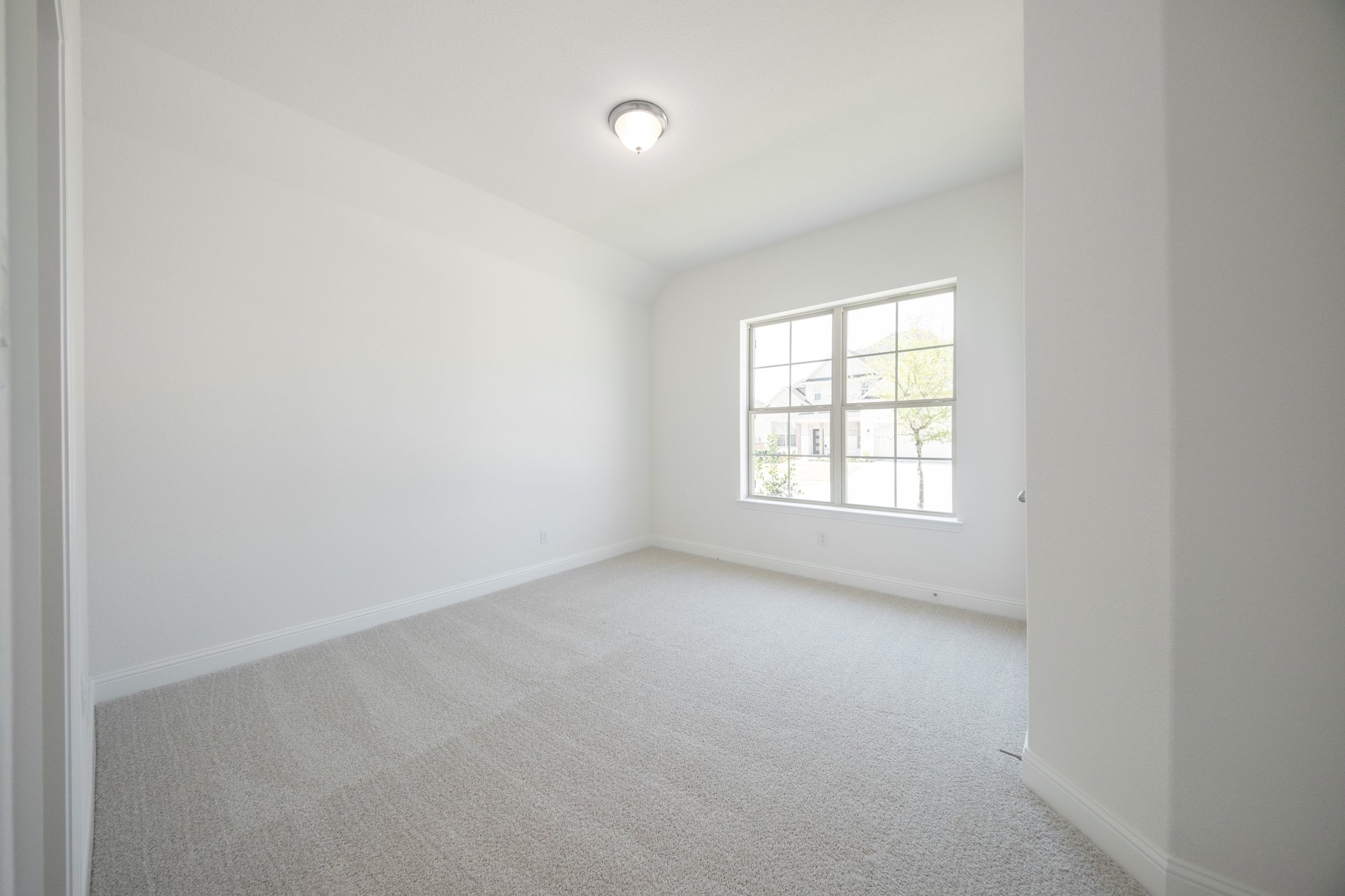 guest bedroom with carpet and walk-in closet
