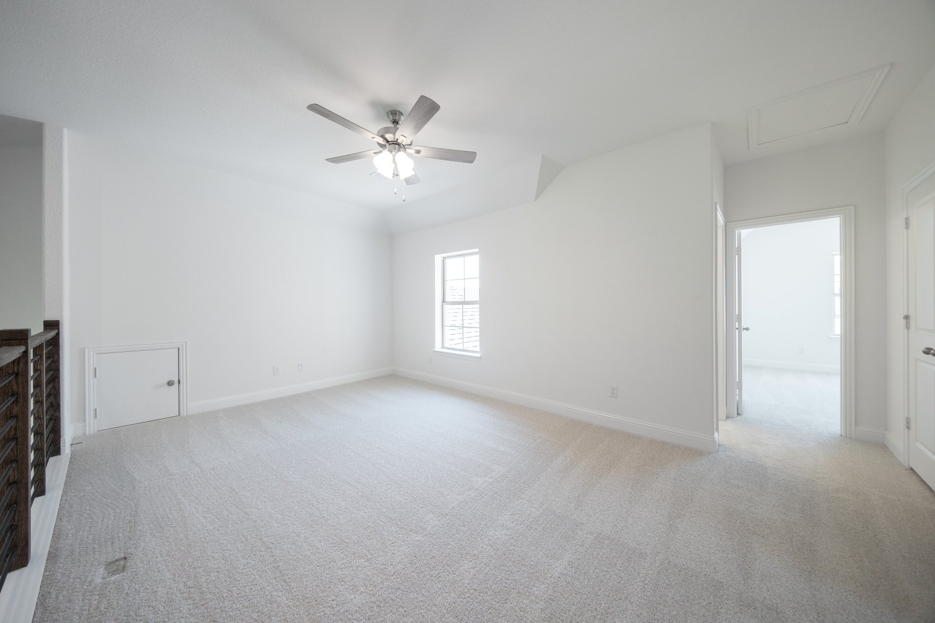 spacious game room with carpet and ceiling fan