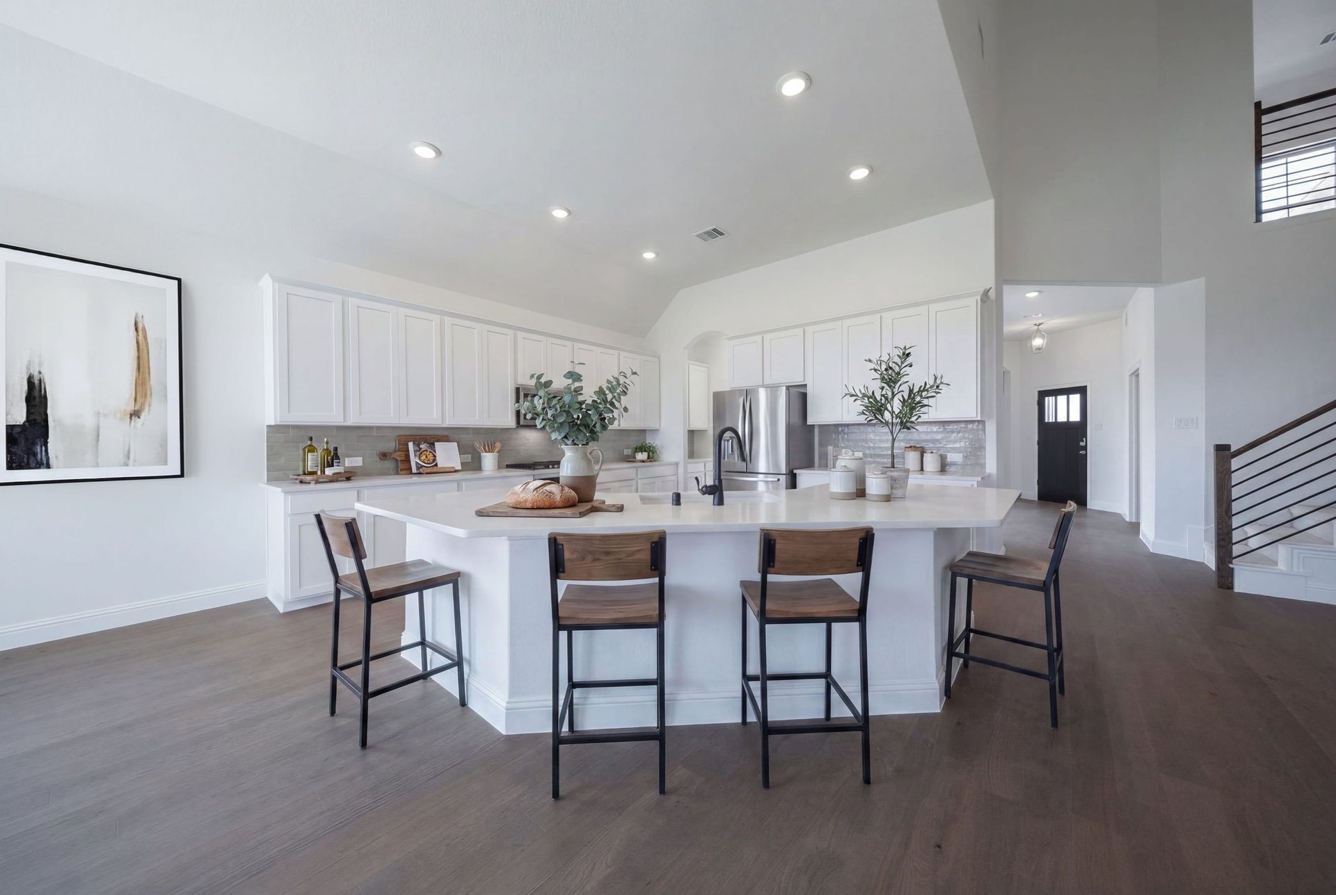 open kitchen with white cabinets and hardwood flooring