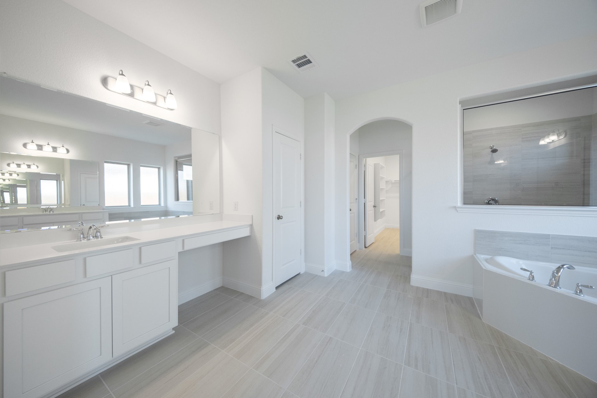 spacious primary bathroom with soaking tub