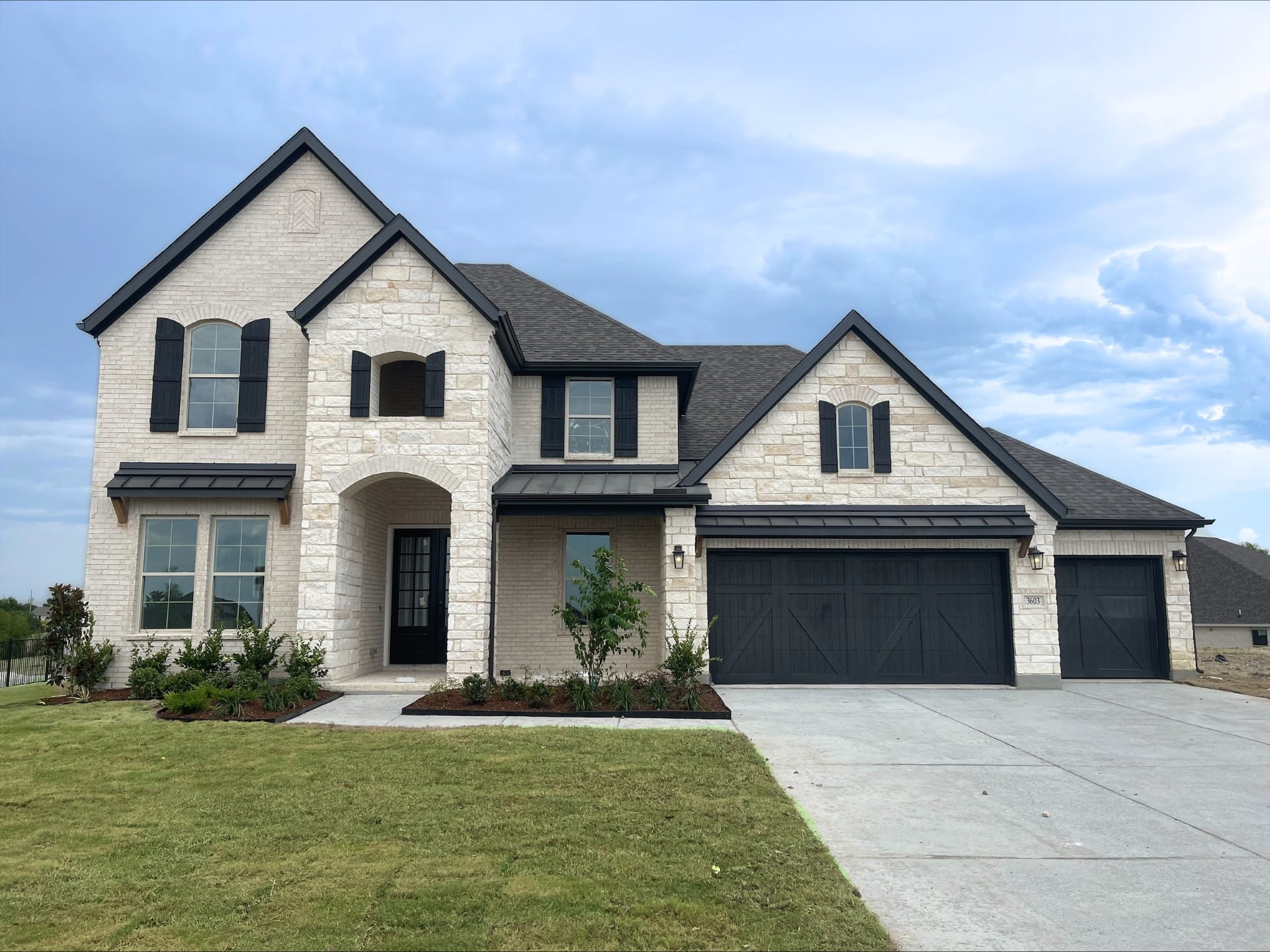 exterior of home with white brick and black siding