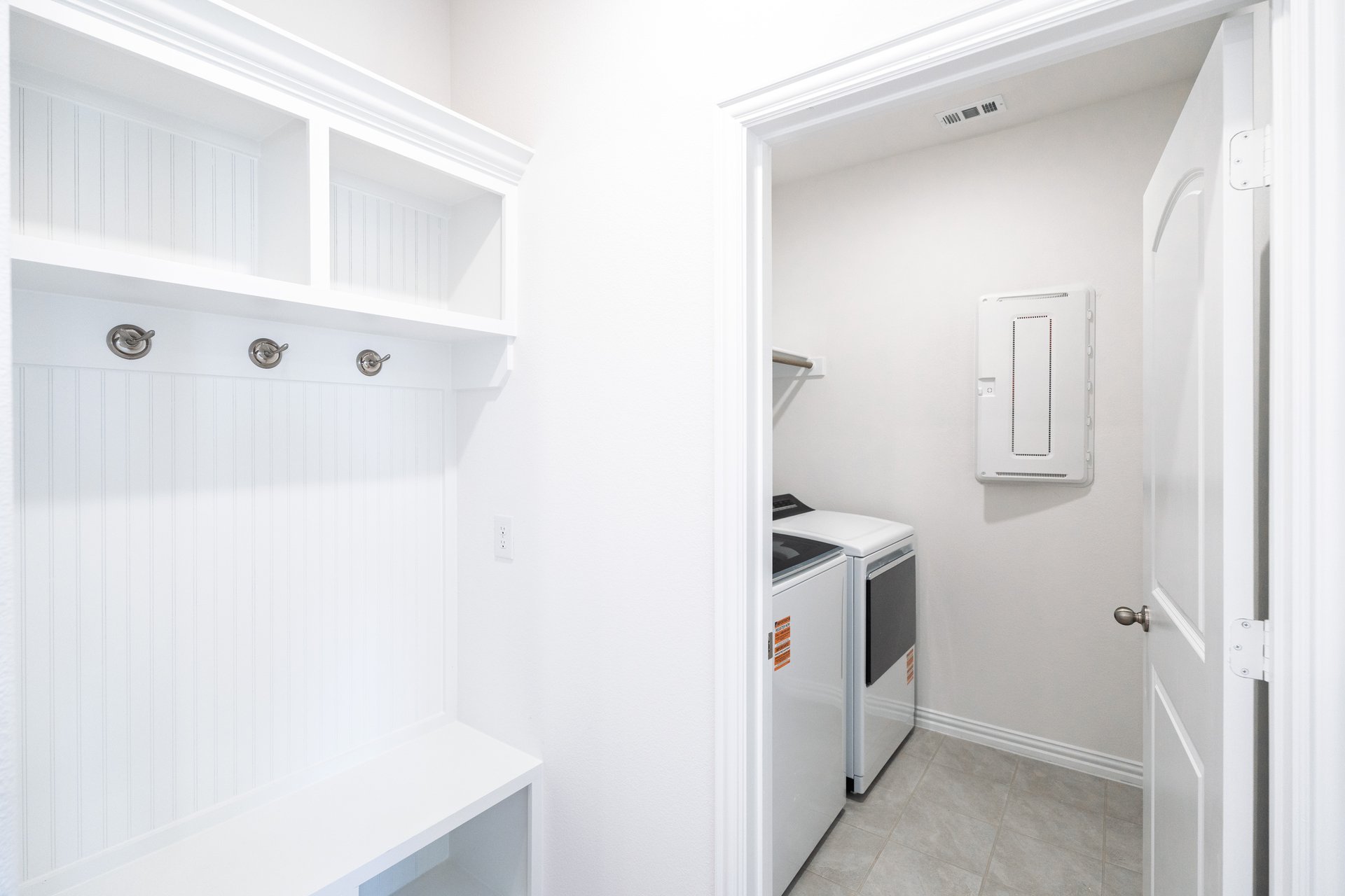 laundry room with white cabinets