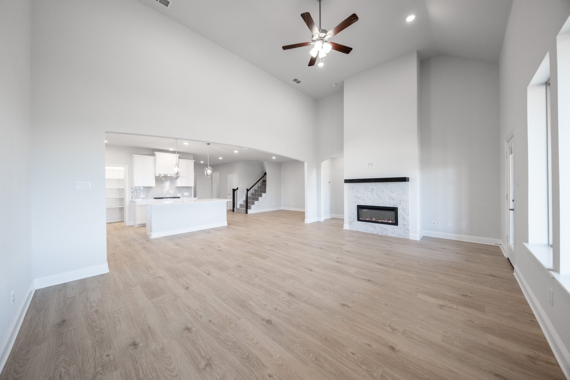 open great room with wood floors and fireplace