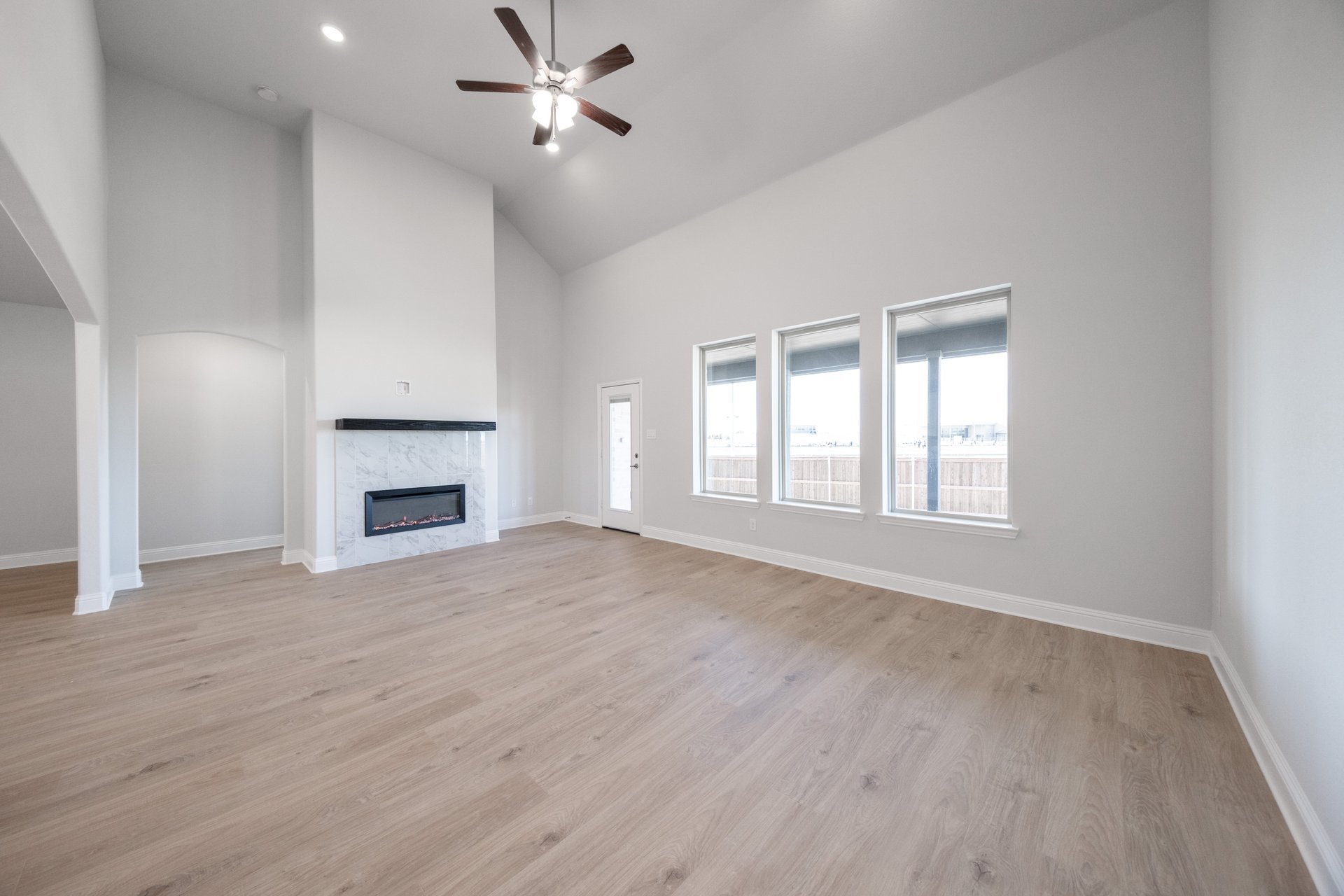 open great room with wood floors and fireplace