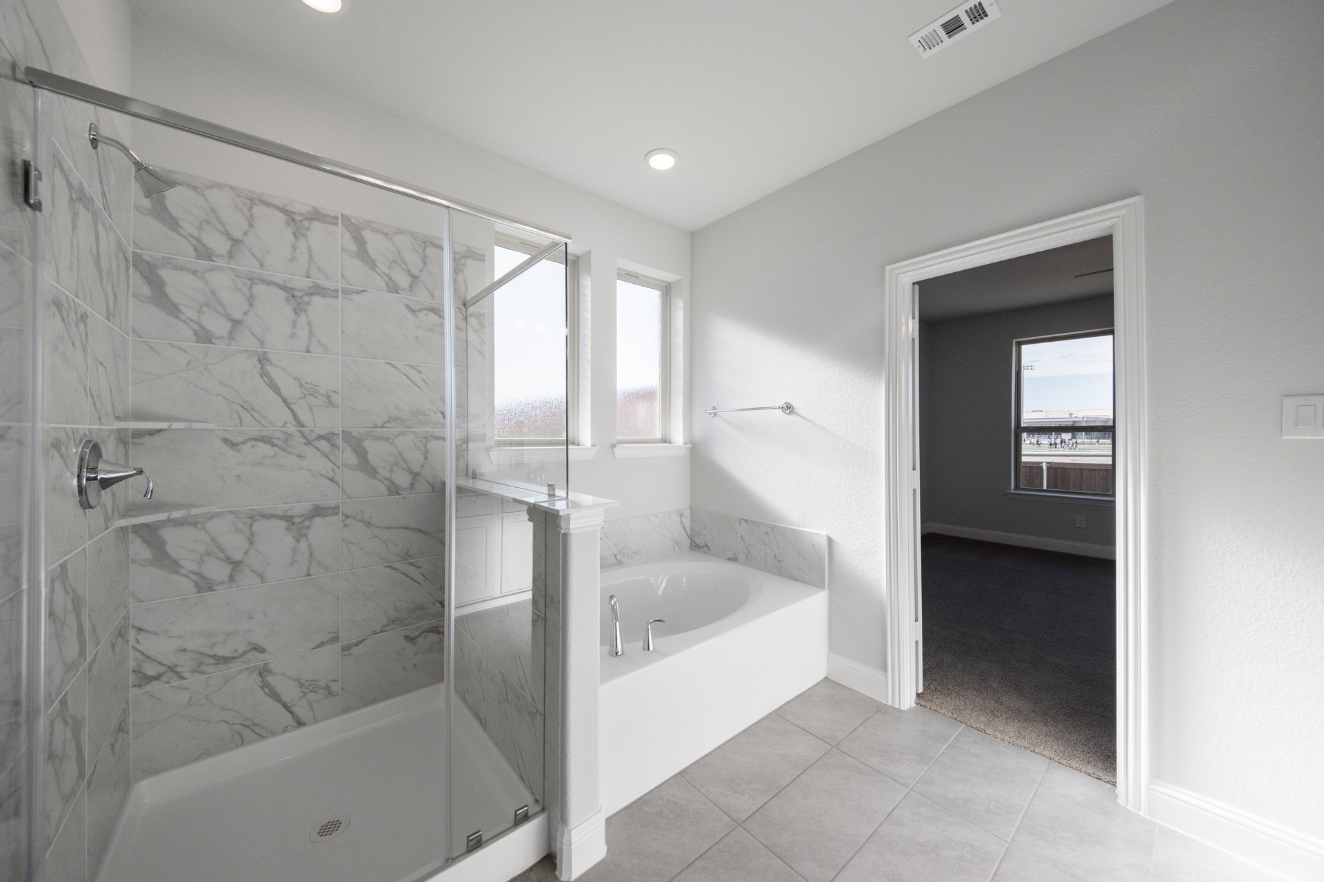 primary bathroom with soaking tub and walk-in shower