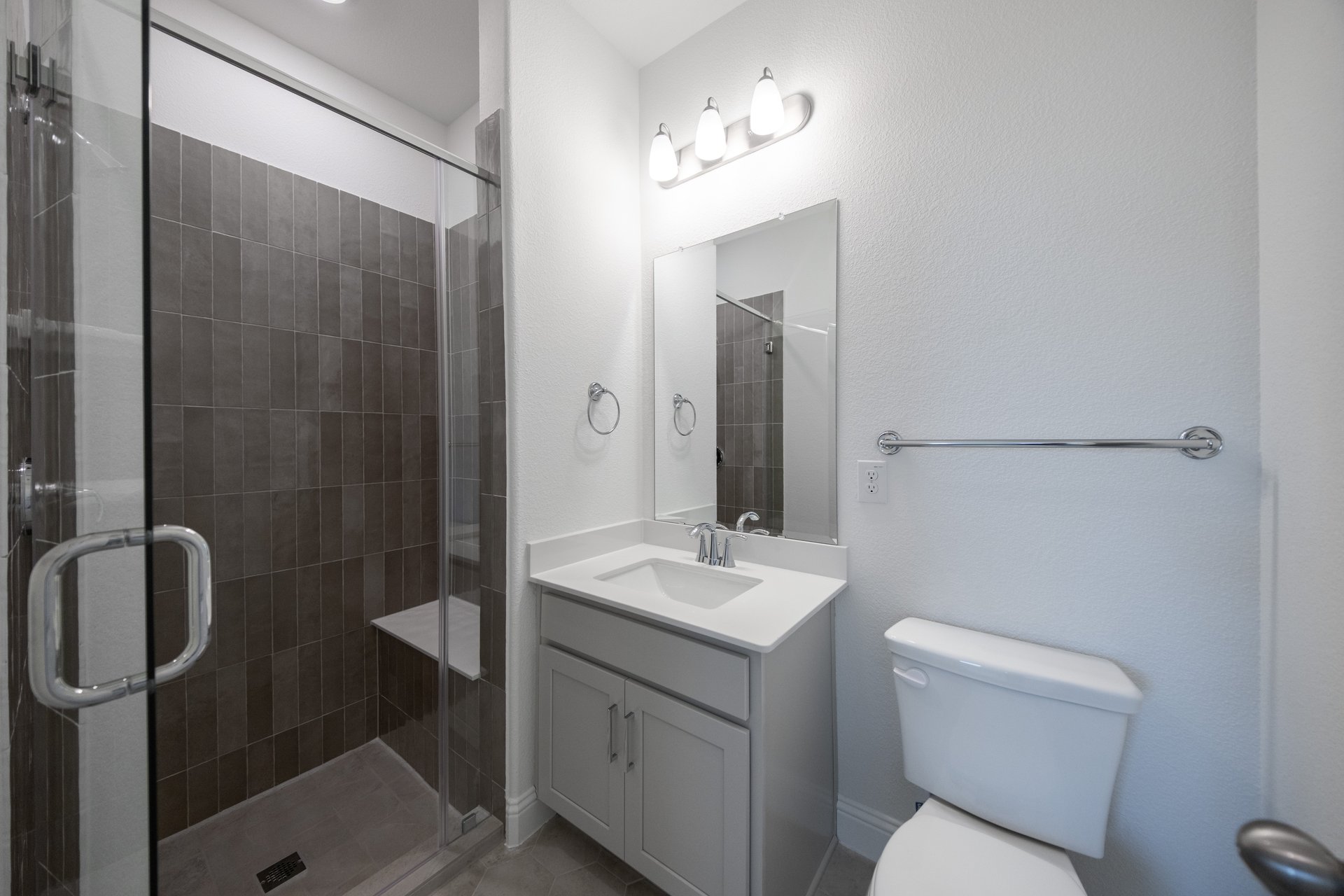 bathroom with walk-in shower and tile 