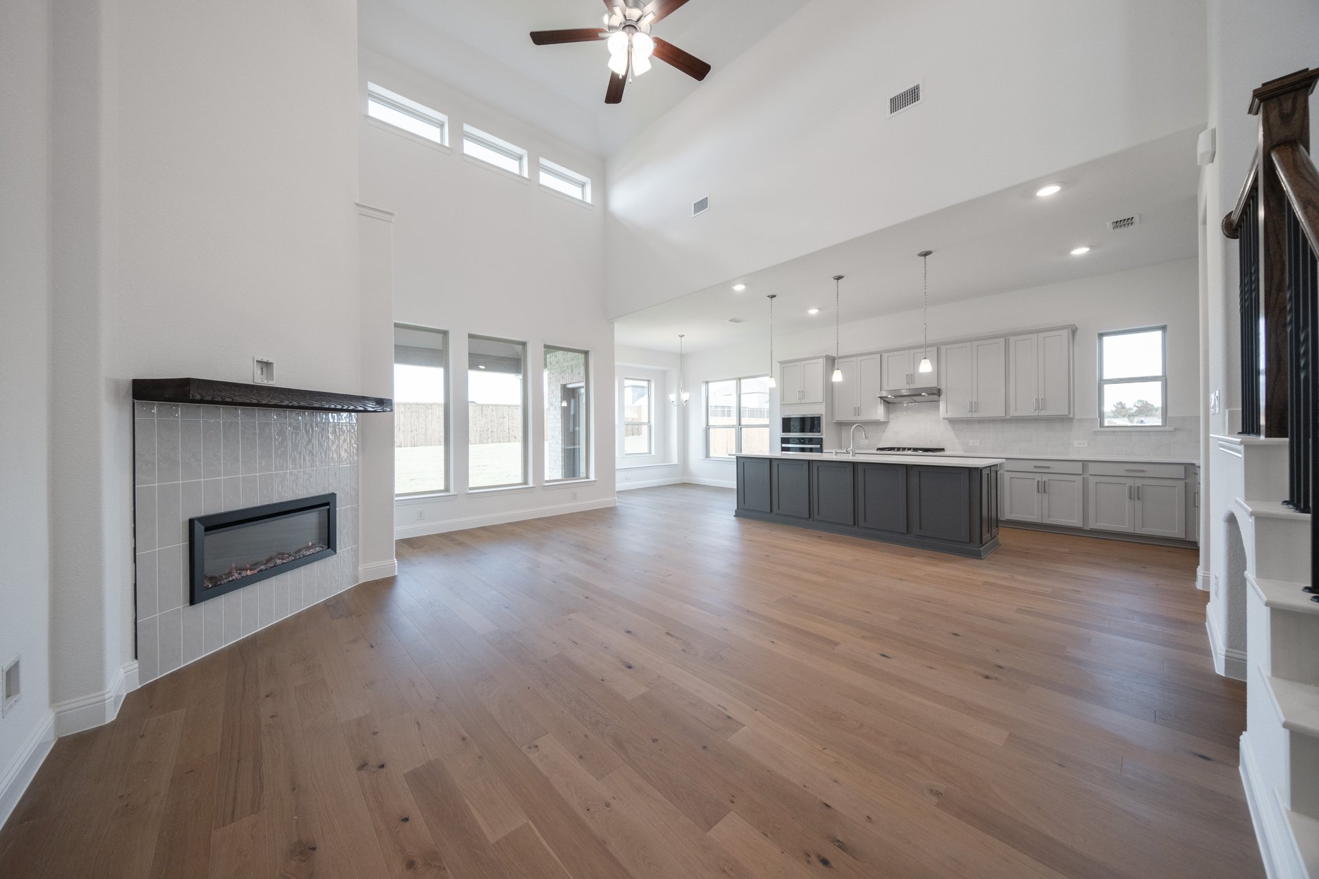 great room with high ceilings and wood flooring 