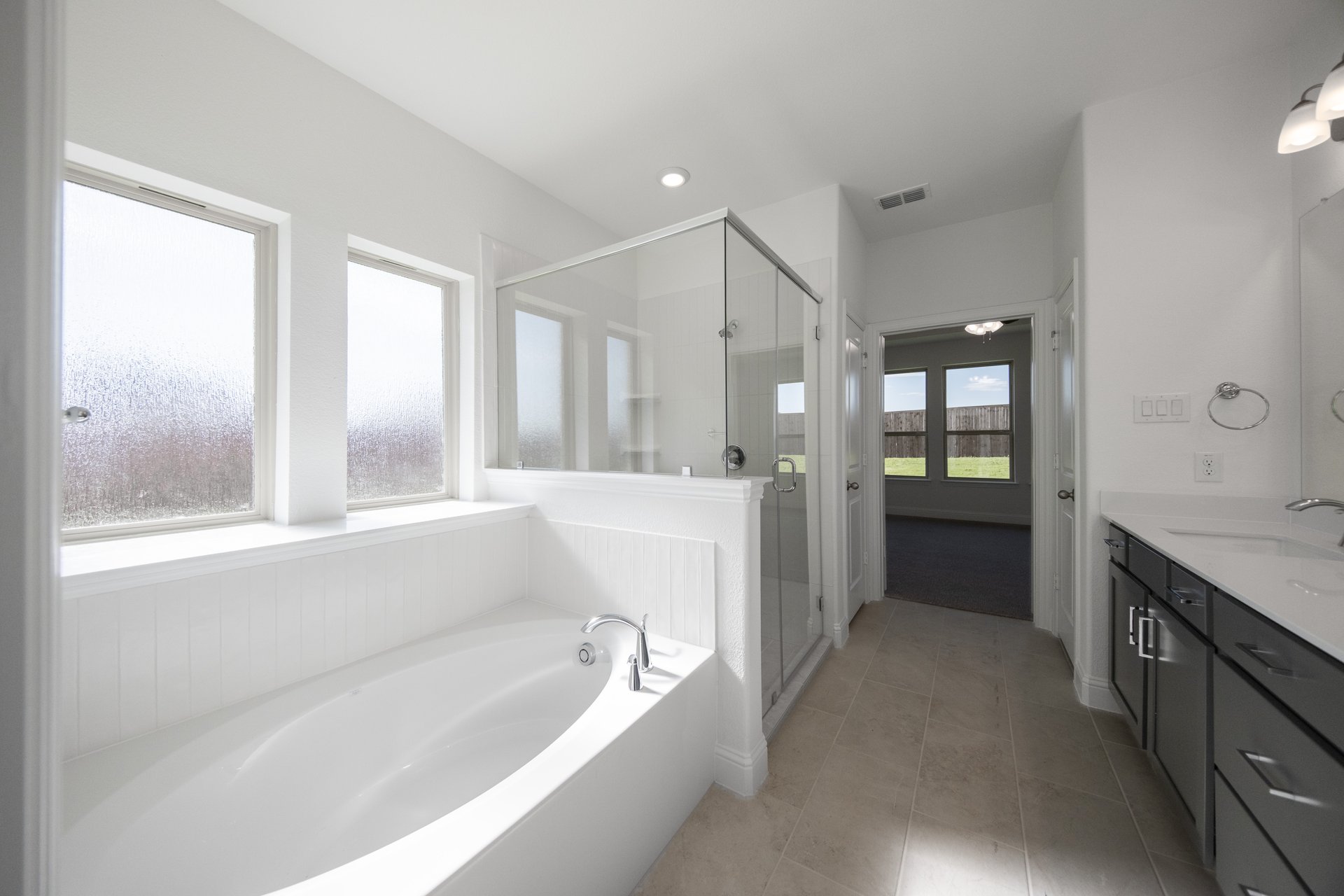 bathroom with large soaking tub and walk-in shower