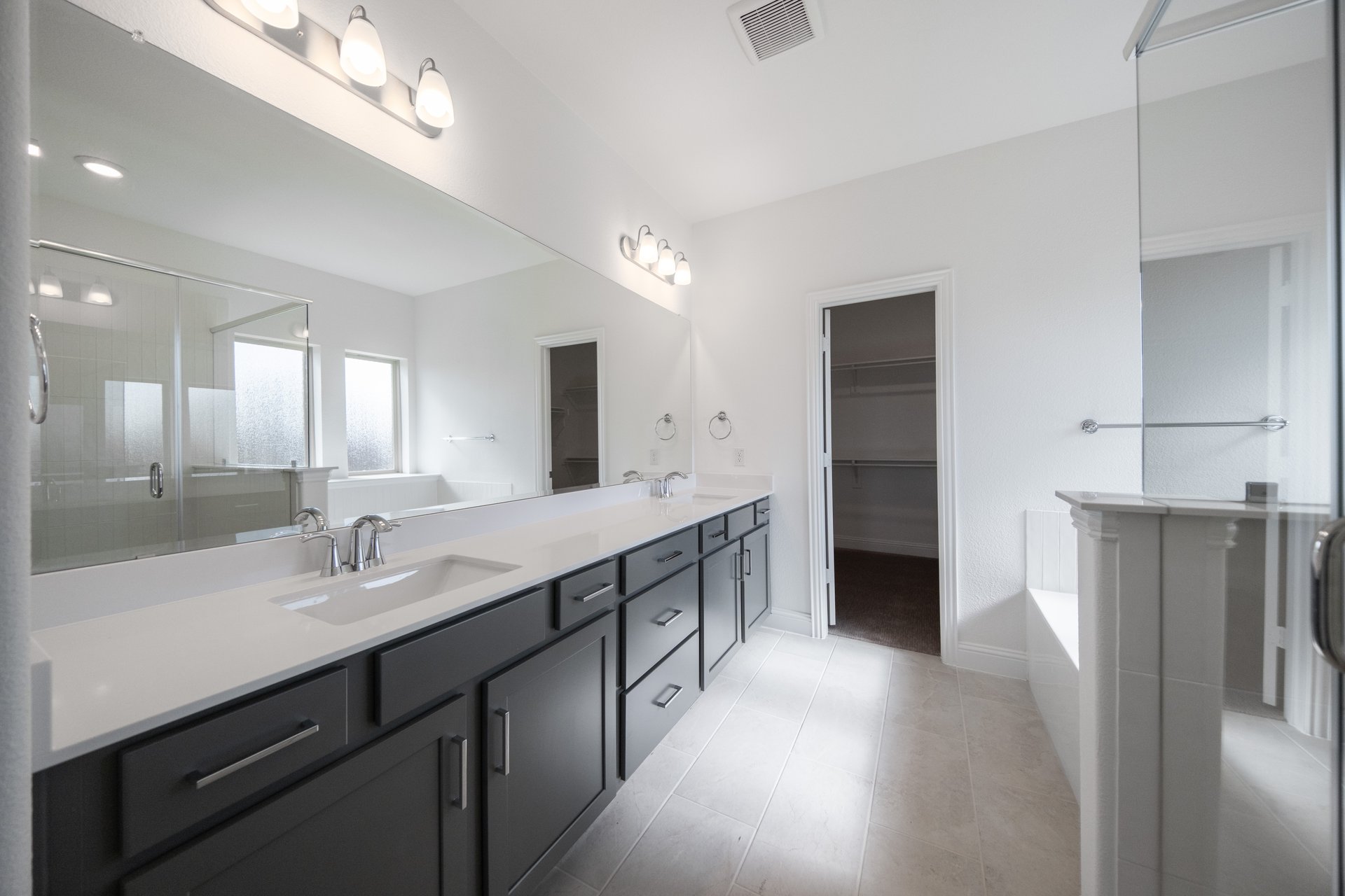 bathroom with dark cabinets and white countertops 