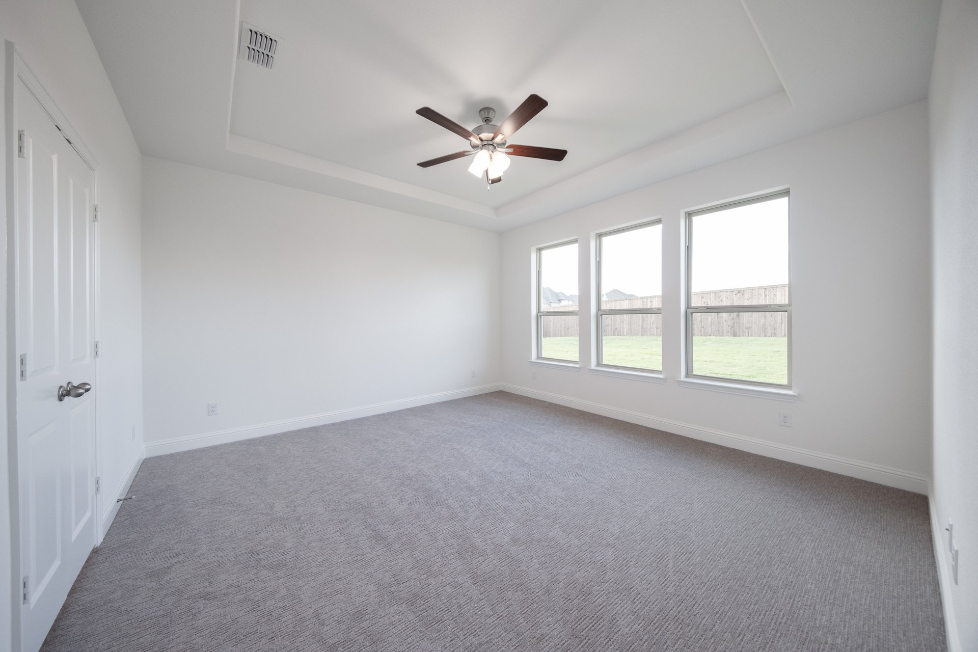 bedroom with large windows and carpet 