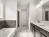 primary bathroom with dual sinks, soaking tub abd walk-in shower 