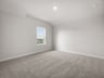 seconday bedrooom with carpet, window and lighting