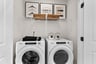 laundry room with a washer & dryer and a wire shelf