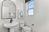 powder room with a window and a pedestal sink