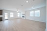 open great room with wood floors and fireplace