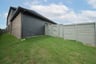 backyard of home with gray fence