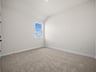 secondary bedroom with carpet and window