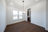 dining room with wood flooring and chandelier 