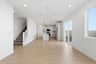 great room with light wood floors, white walls, recessed ceiling lights, and sliding glass door to backyard