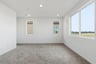 bedroom with tan carpet, white walls, three windows, and recessed ceiling lights