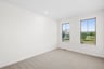 secondary bedroom with carpet and two windows