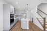 kitchen with gray cabinetry and hardwood floors